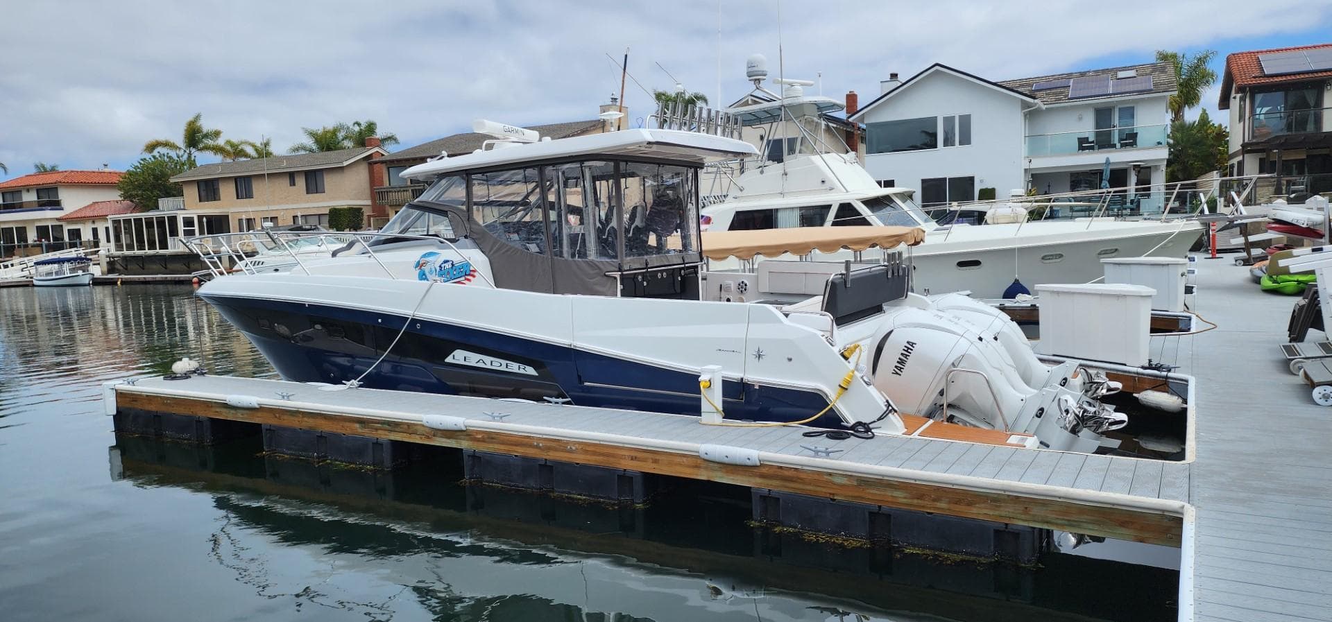 2022 Jeanneau Leader 12.5 WA docked in a marina, featuring sleek design and powerful engines.