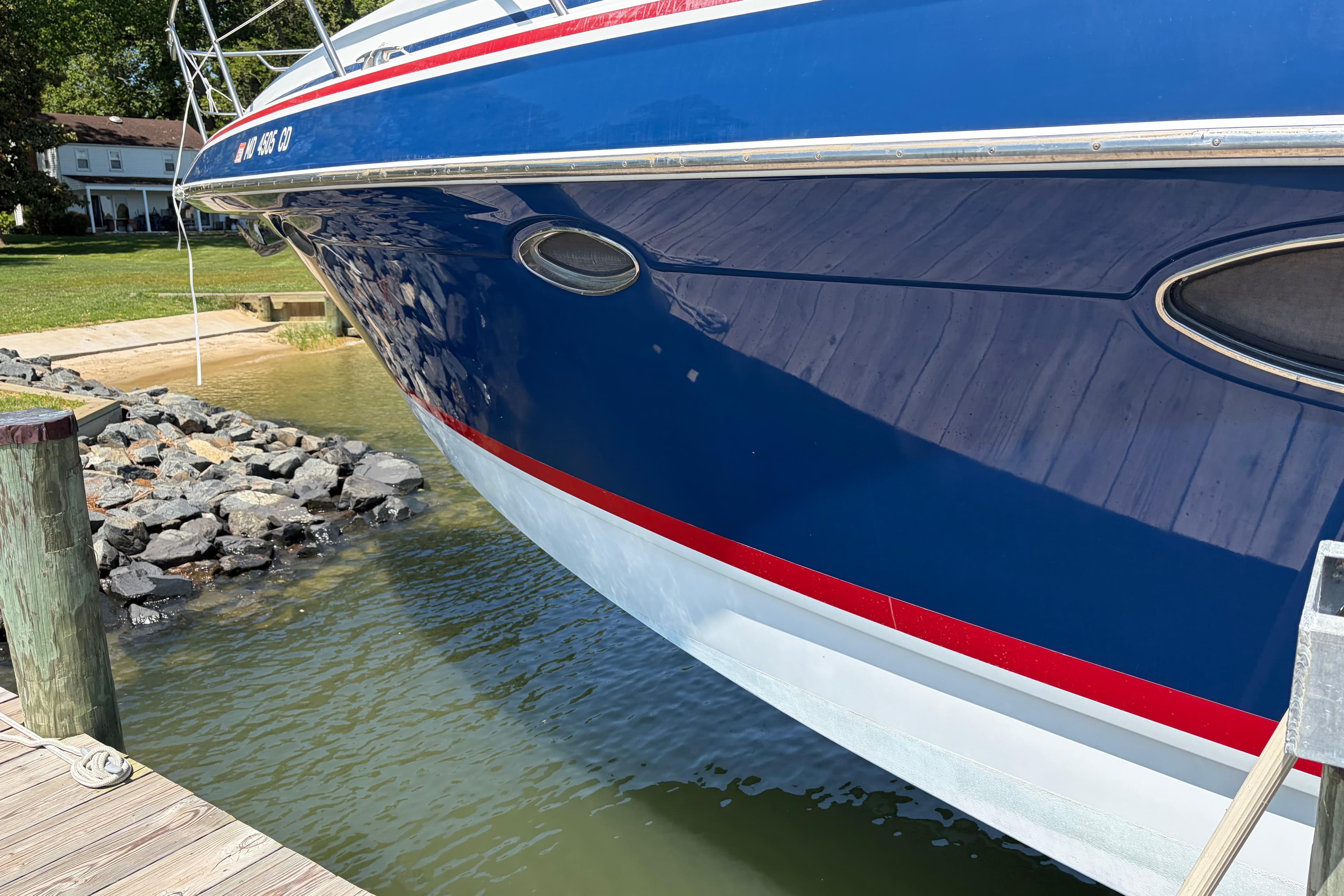 2011 Formula 45 Yacht docked, showcasing sleek blue hull and red accents.
