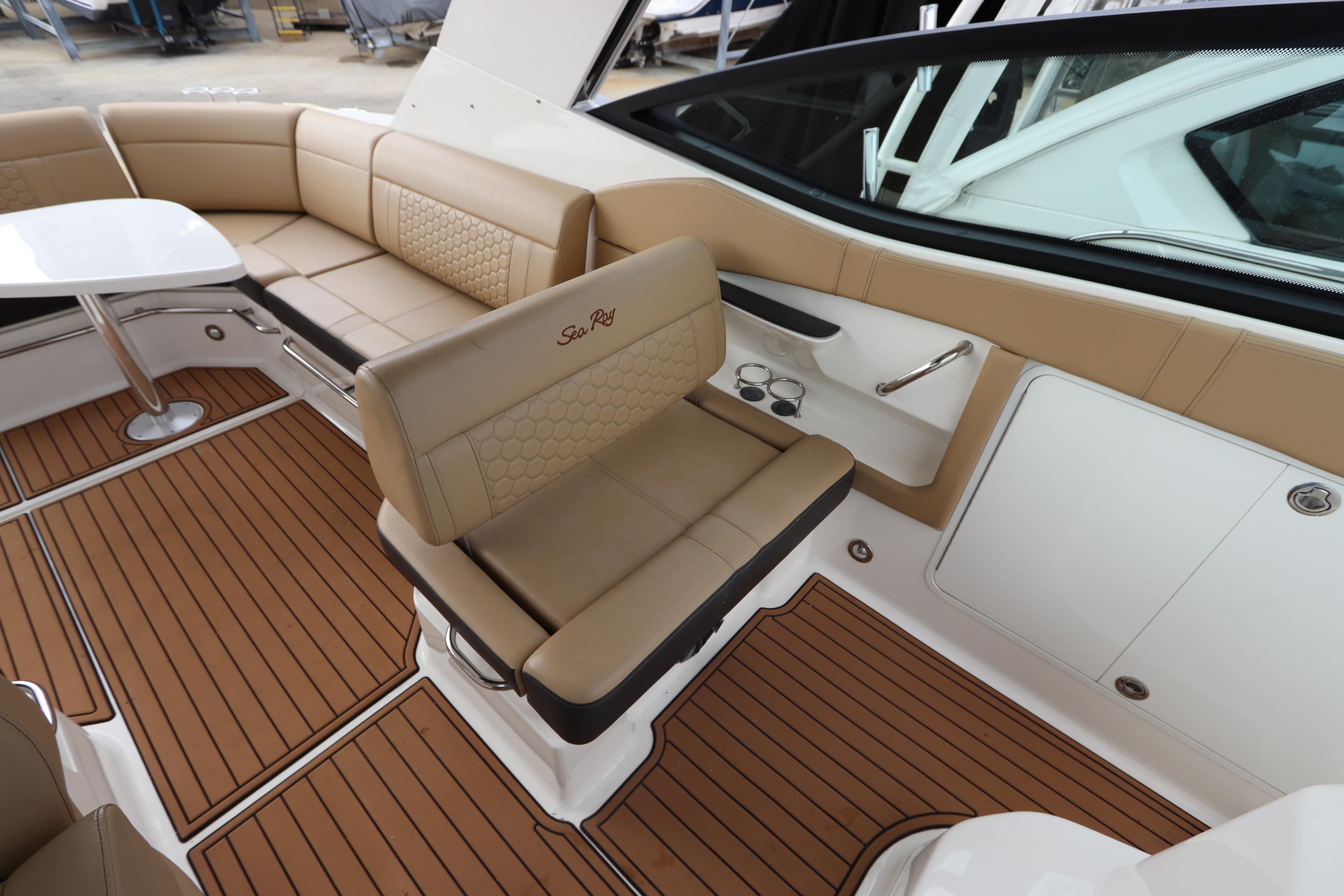 2019 Sea Ray Sundancer 320 interior with tan seating and wood-style flooring.