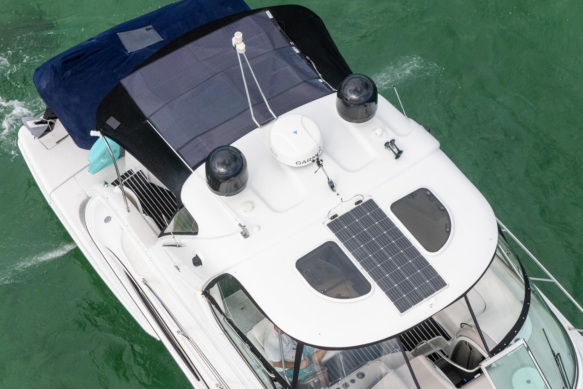 2005 Formula 48 Yacht with solar panels on the roof, cruising in green waters.