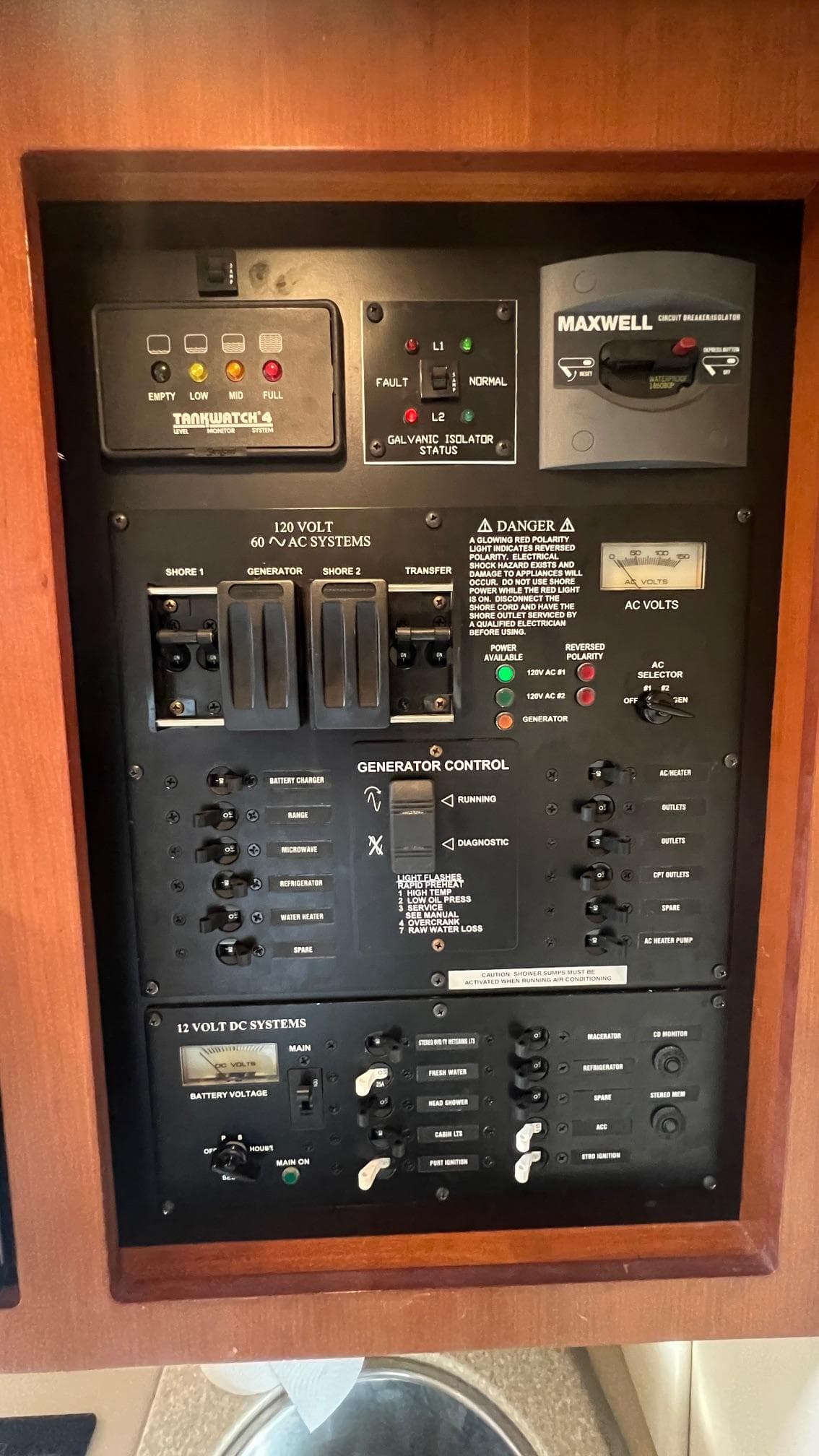 2006 Rampage 30 Offshore control panel with switches and gauges in wooden frame.