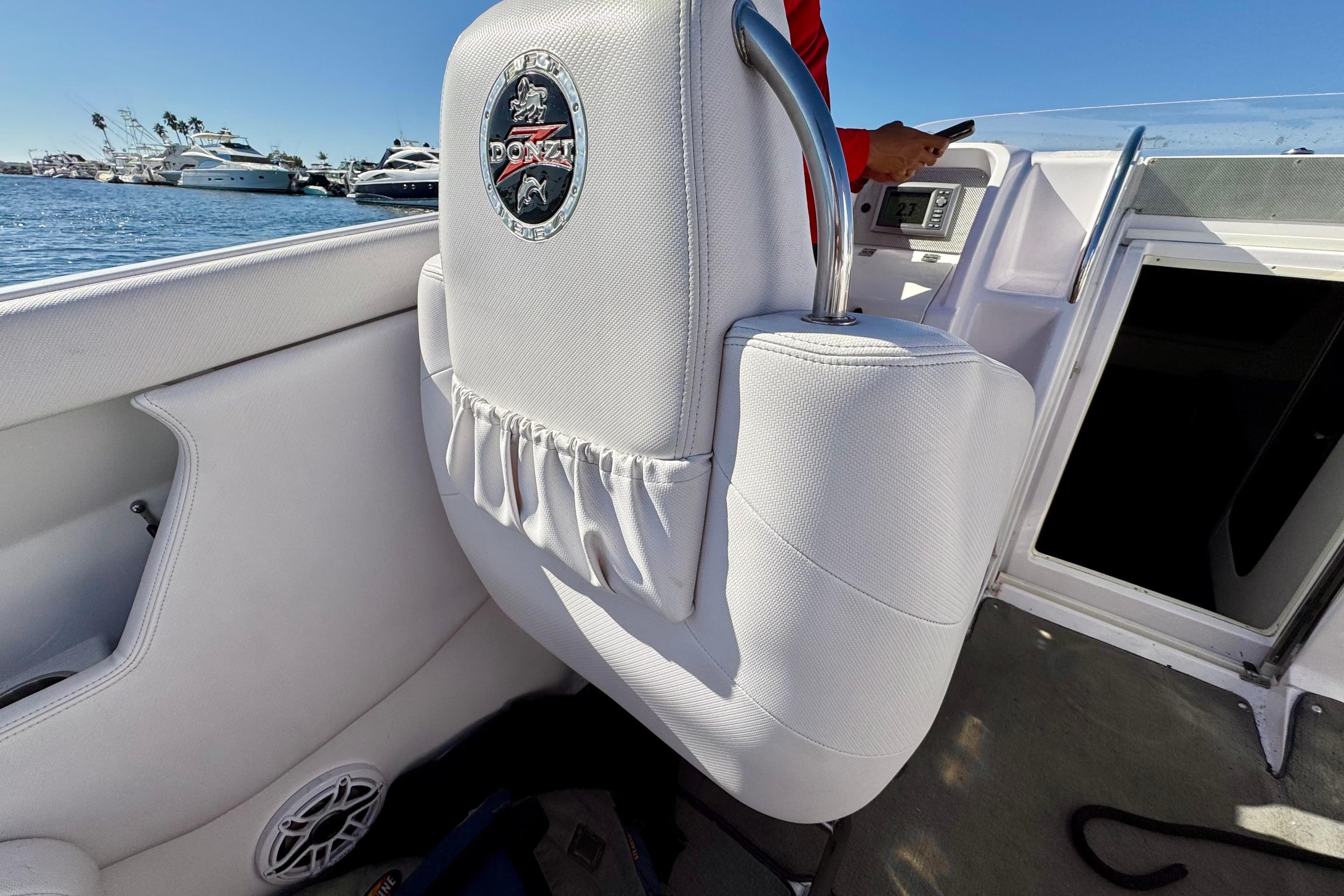 Interior of a 2015 Donzi 38 ZR boat with white seating and logo.