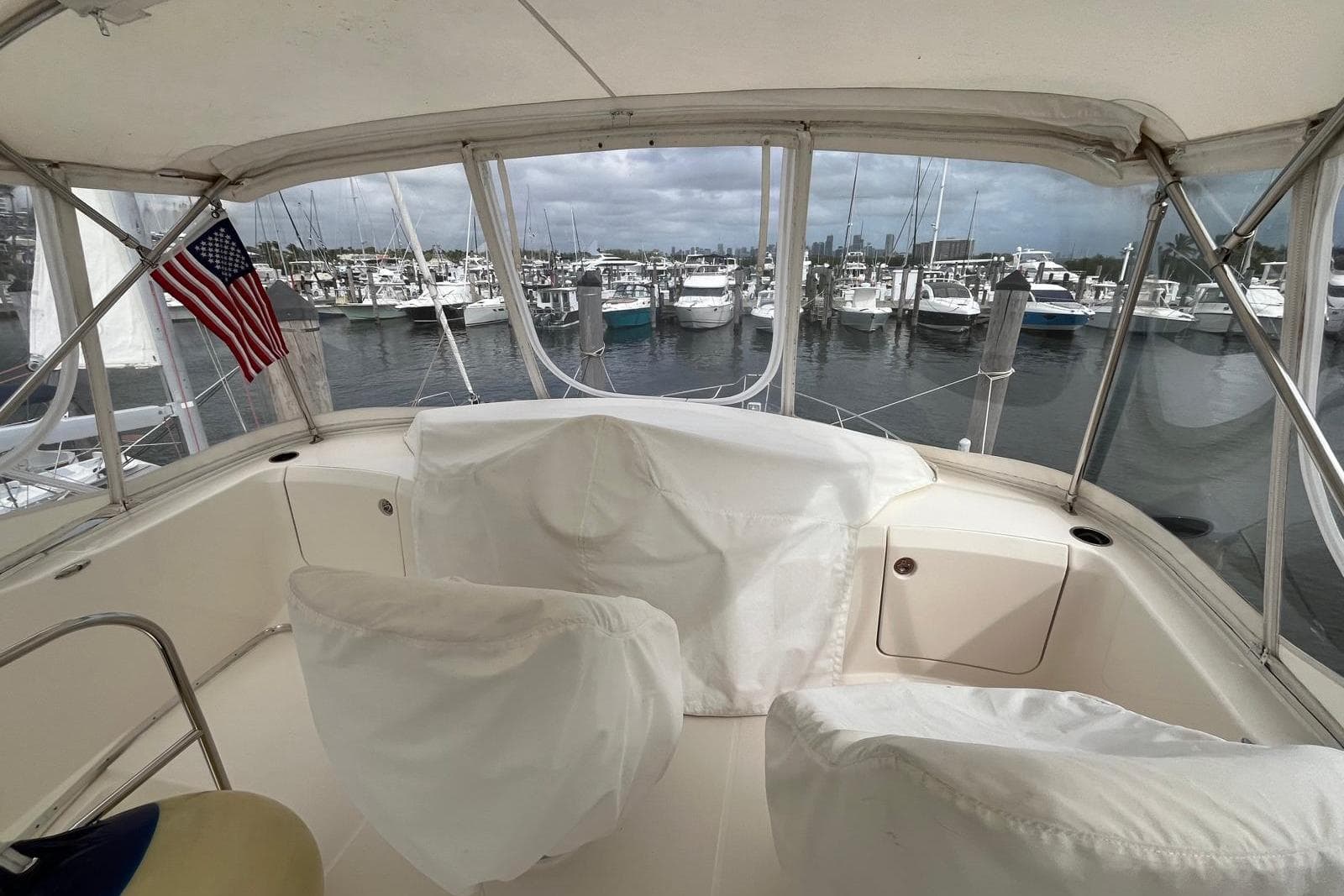 2005 Silverton 34 Convertible yacht interior with marina view and American flag.
