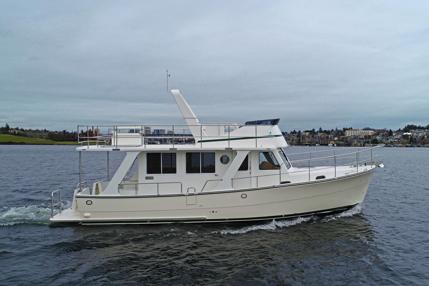 2026 Helmsman Trawlers 38 Sedan cruising on open water.