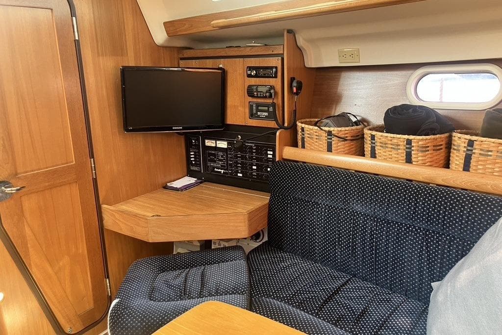 Interior of 2004 Catalina 350 sailboat with TV, control panel, and seating area.