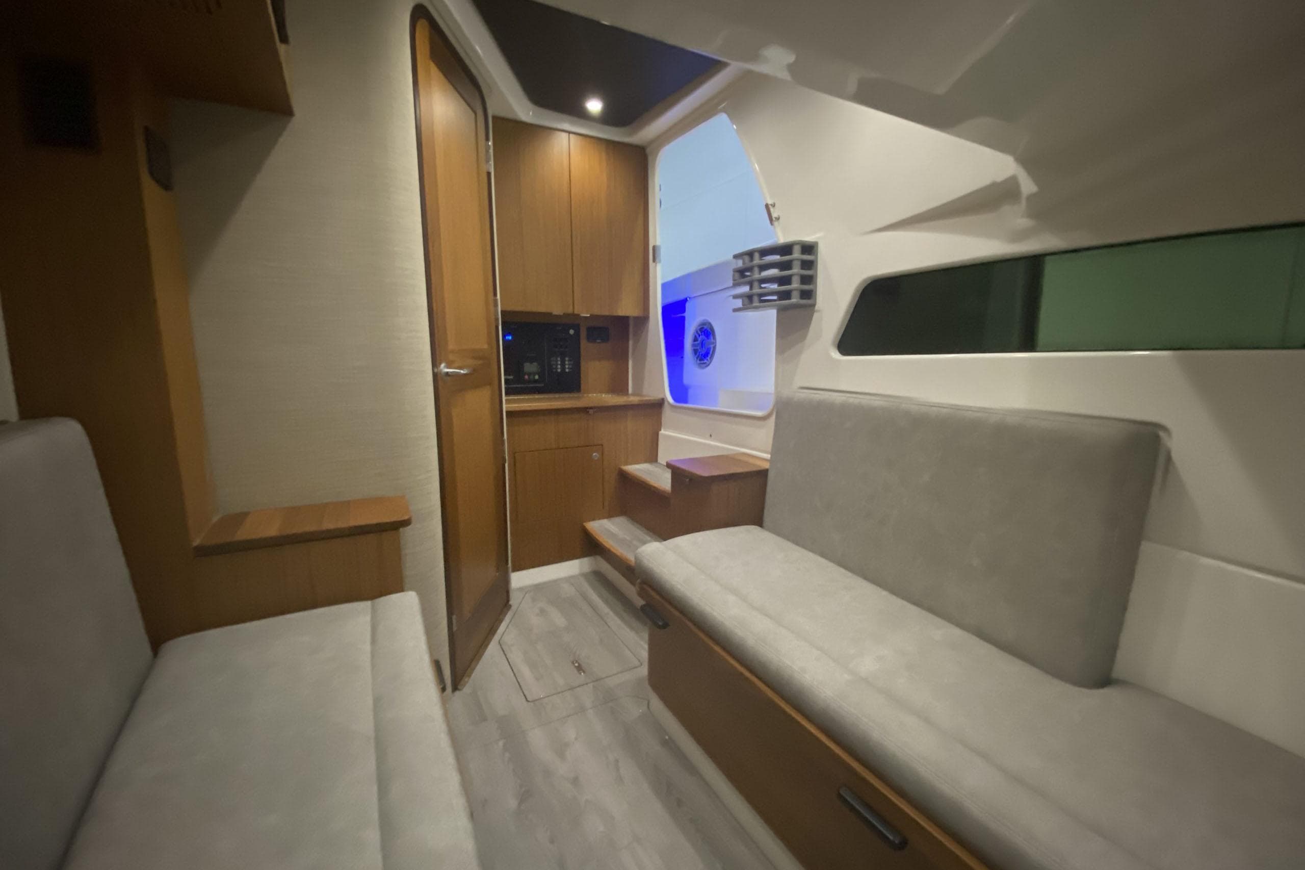 Manufacturer Provided Image: Interior of 2024 Solace 41 CS boat with modern seating and wooden cabinetry.