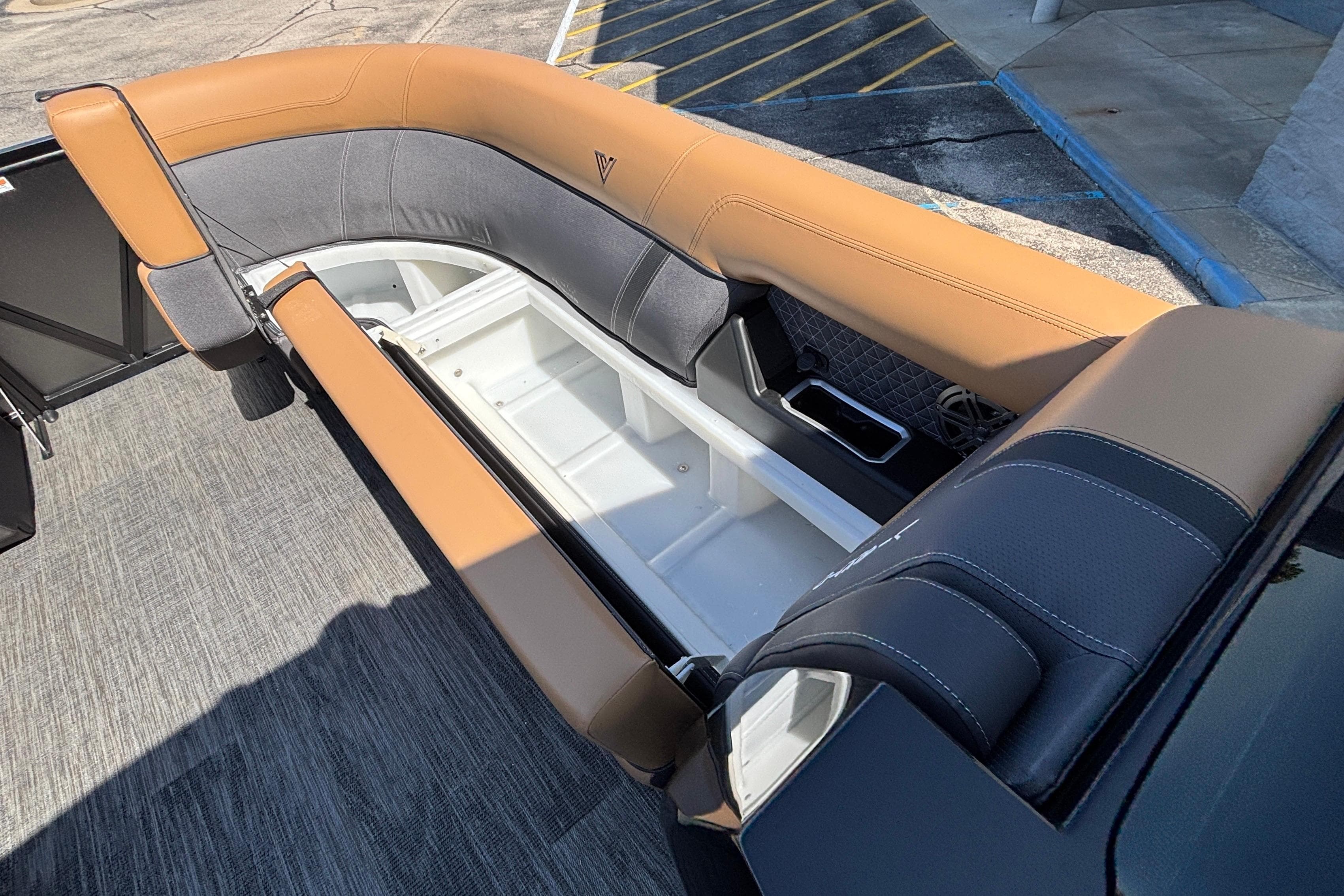 2026 Viaggio Z24U boat interior with tan and gray seating, open storage compartment.