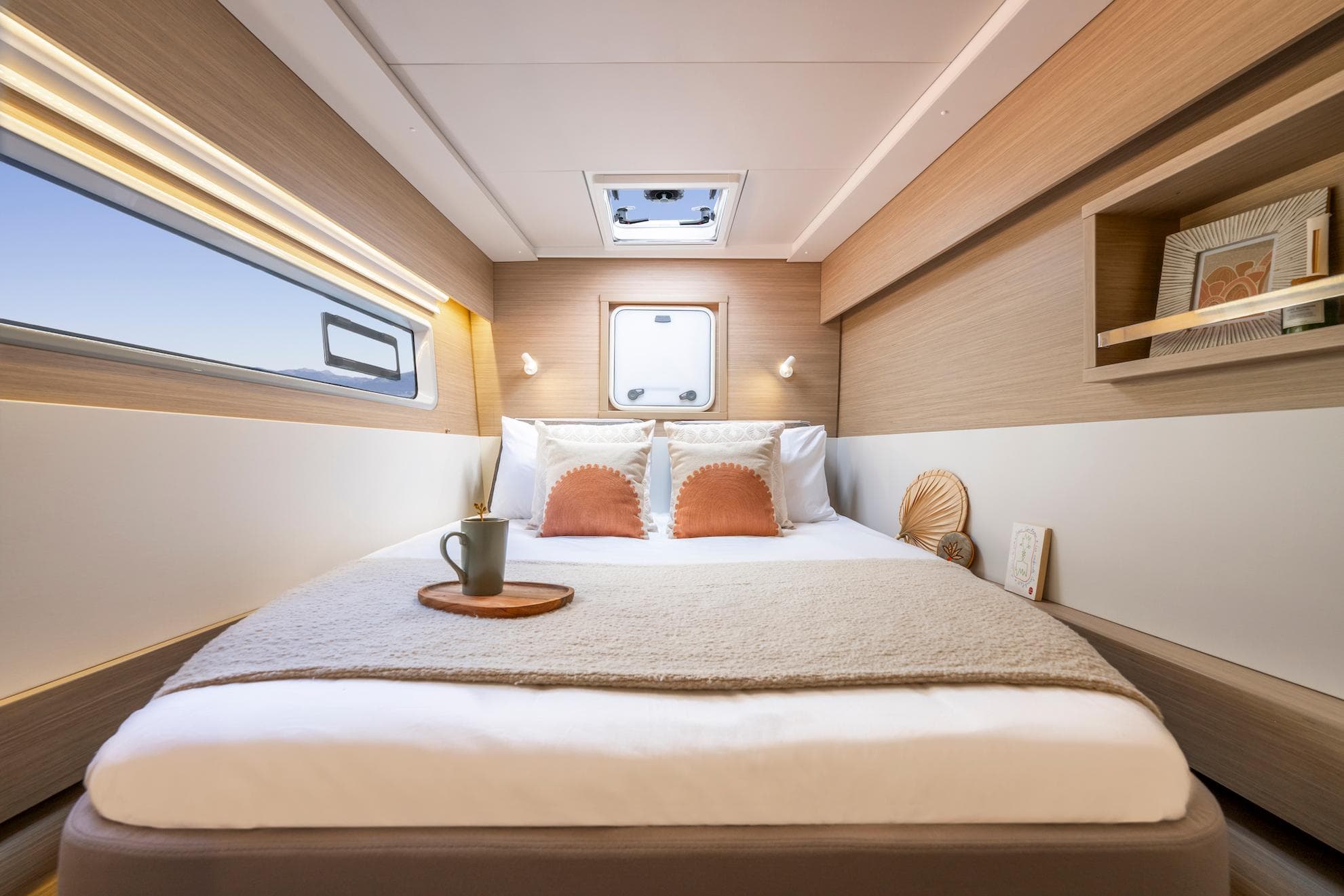 Luxurious cabin interior of 2025 Lagoon 43 yacht with cozy bed and modern decor.