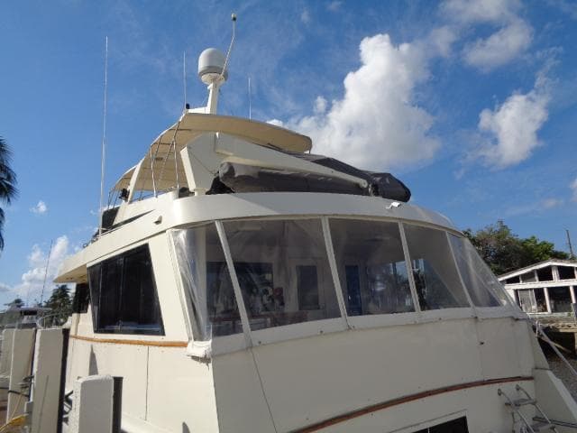 1989 Hatteras 67 Cockpit Motor Yacht under a clear blue sky.
