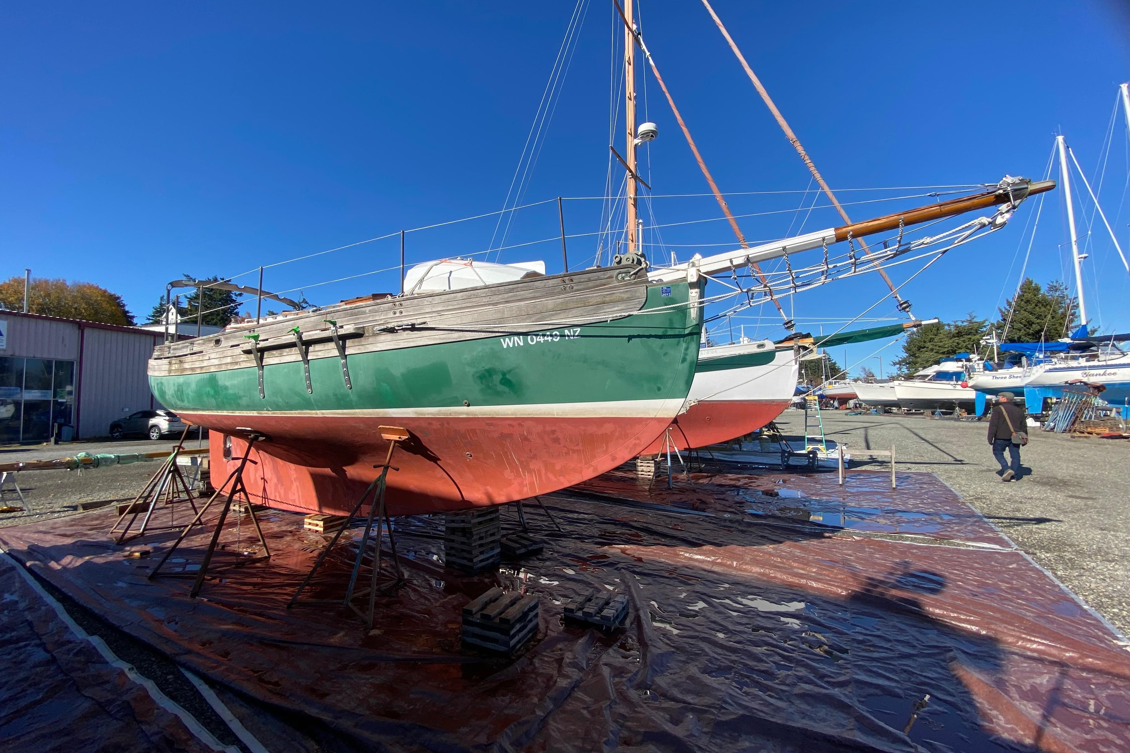 1978 Bristol Channel Cutter 28 sailboat on dry dock under clear blue sky.