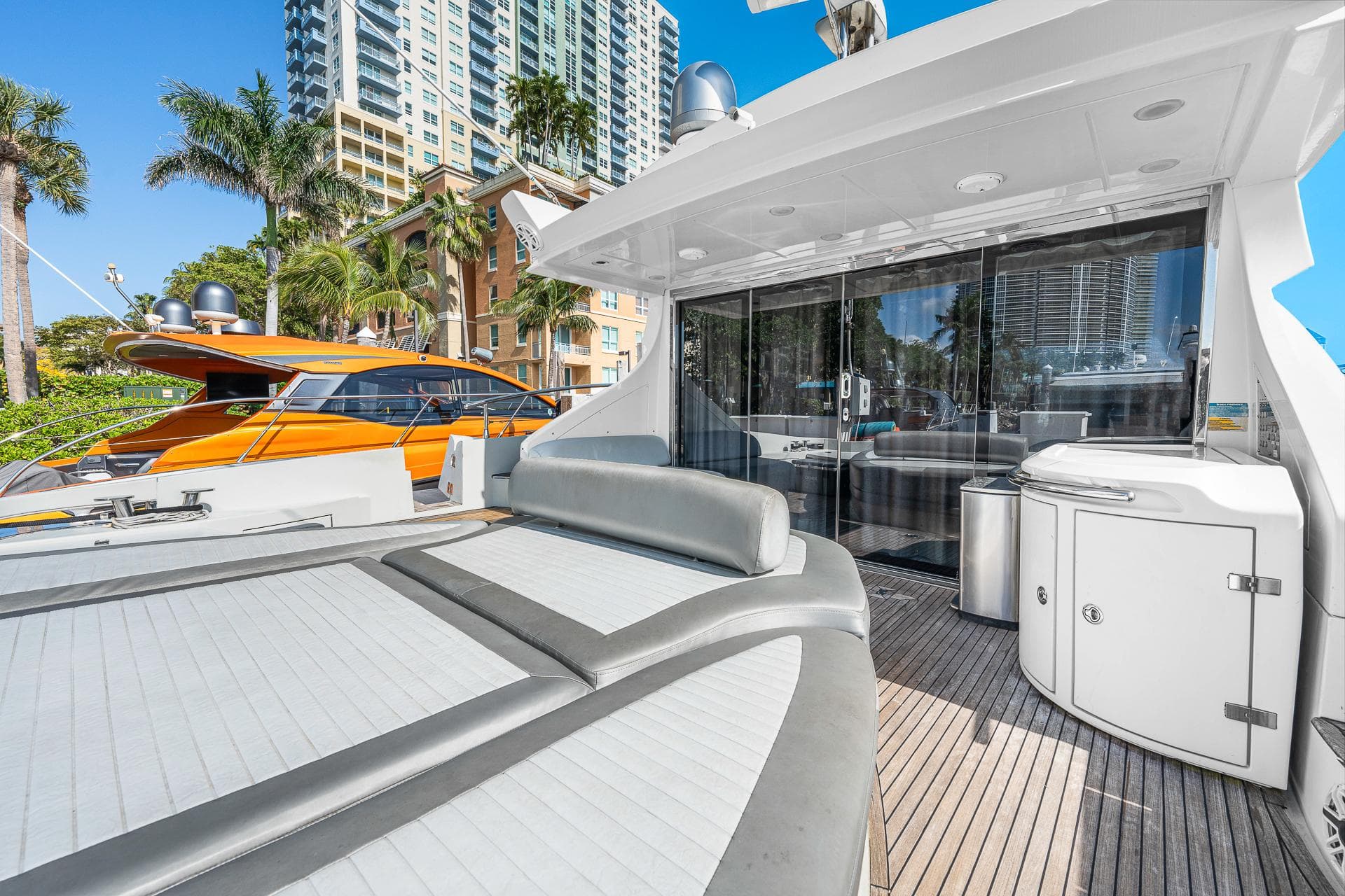 2007 Azimut 62S yacht with spacious deck, modern design, and cityscape backdrop.