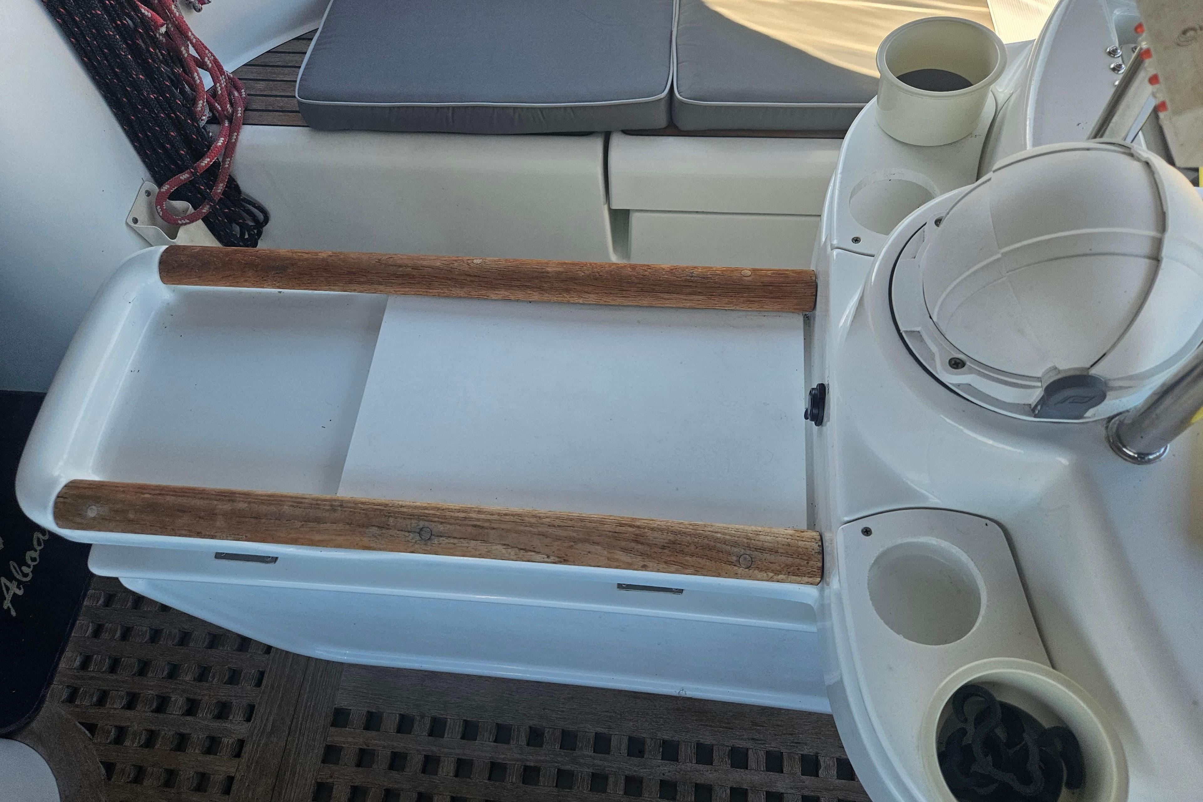 Cockpit of 1998 Beneteau 381 sailboat with seating and cup holders.