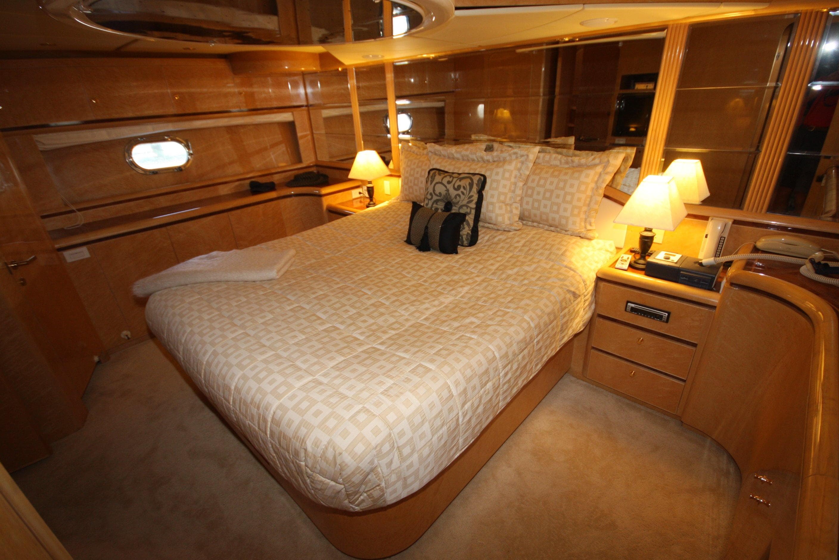 Luxurious bedroom on a 2002 Dyna 77 Laguna yacht.