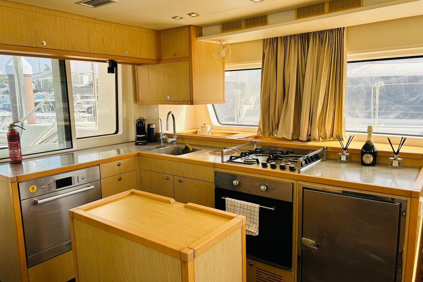 Luxurious kitchen interior of 2013 Lagoon 52F yacht with modern appliances and wood finish.
