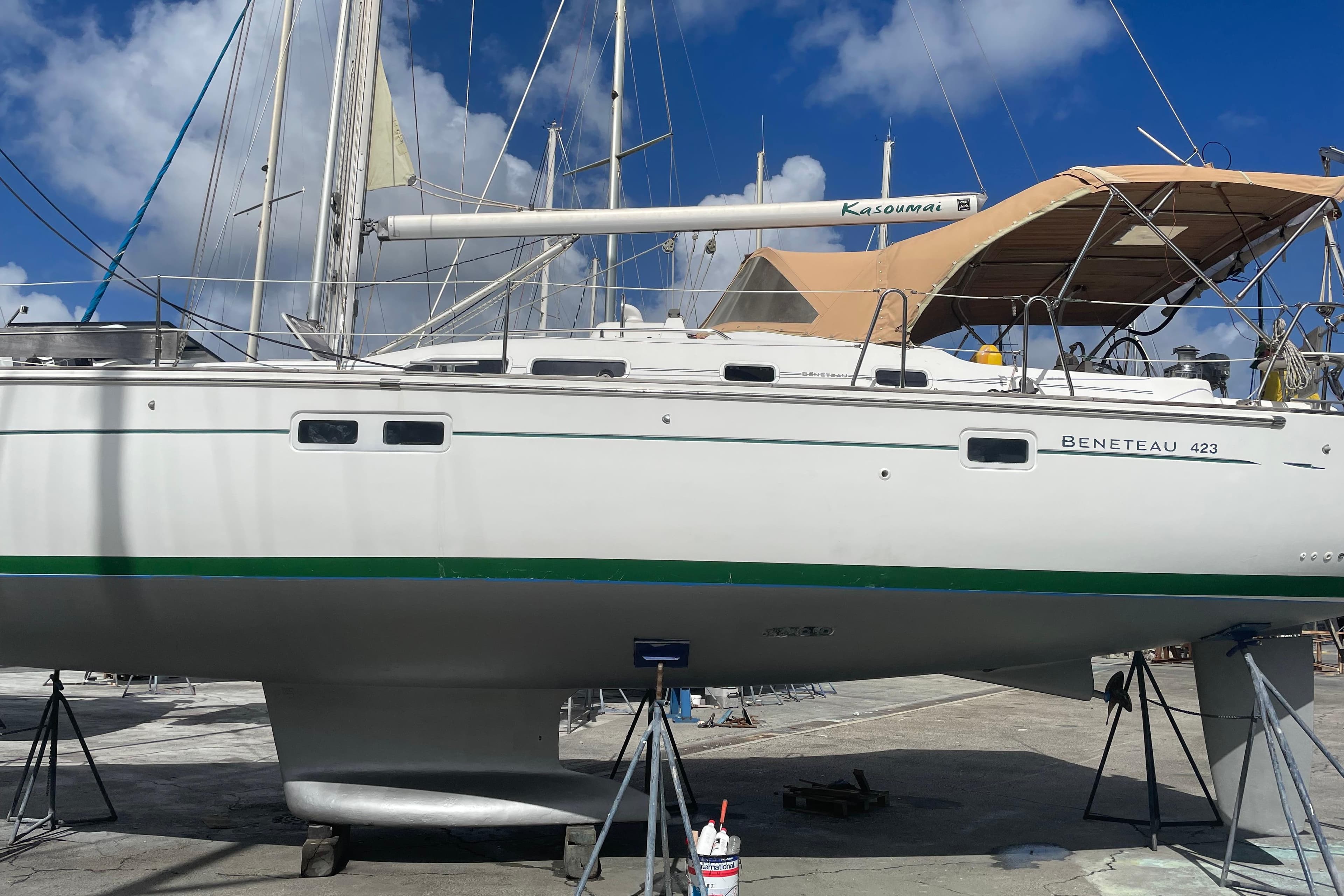 2007 Beneteau 423 sailboat on dry dock under clear blue sky.