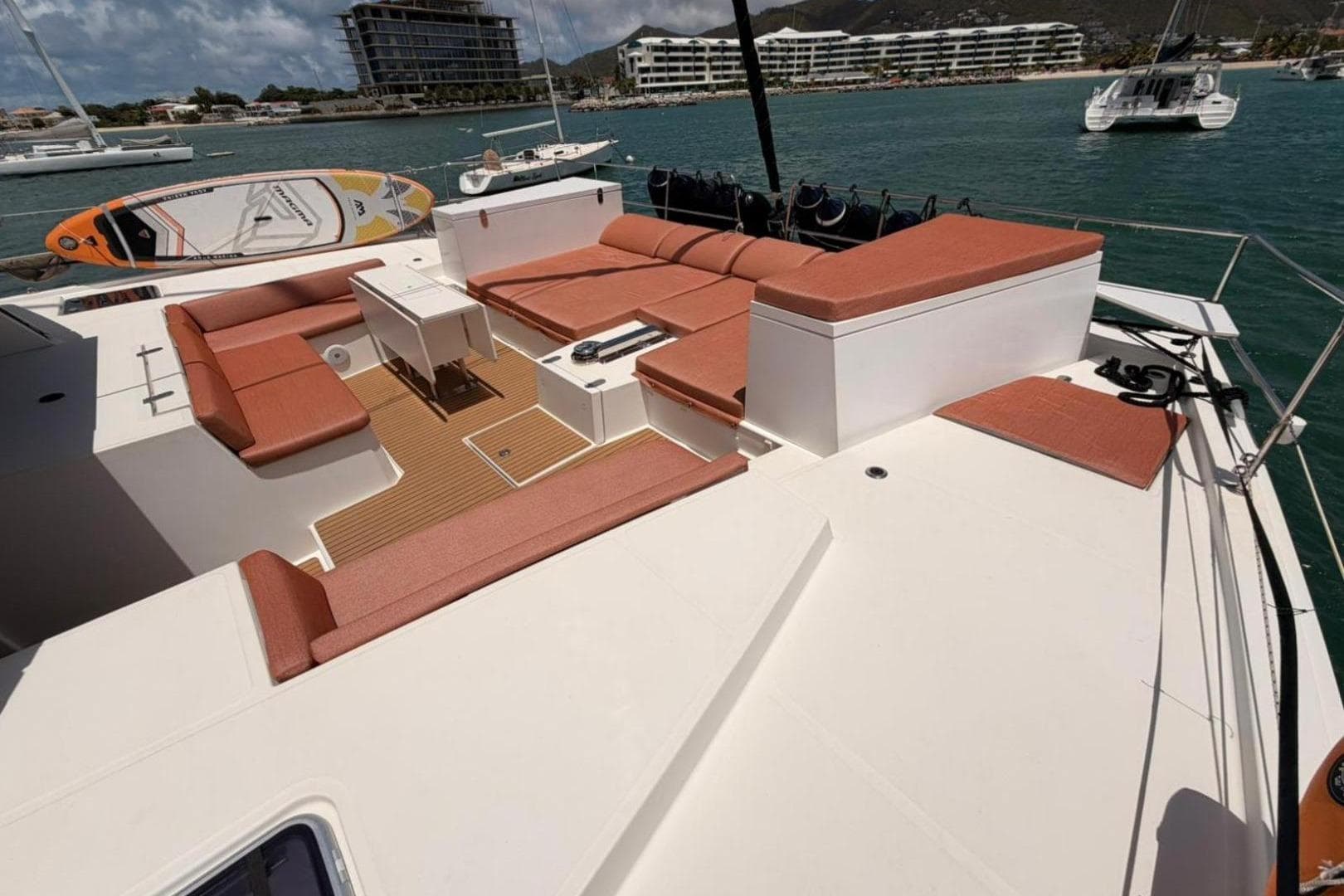 Spacious deck of 2020 Bali 5.4 catamaran with seating and scenic marina view.