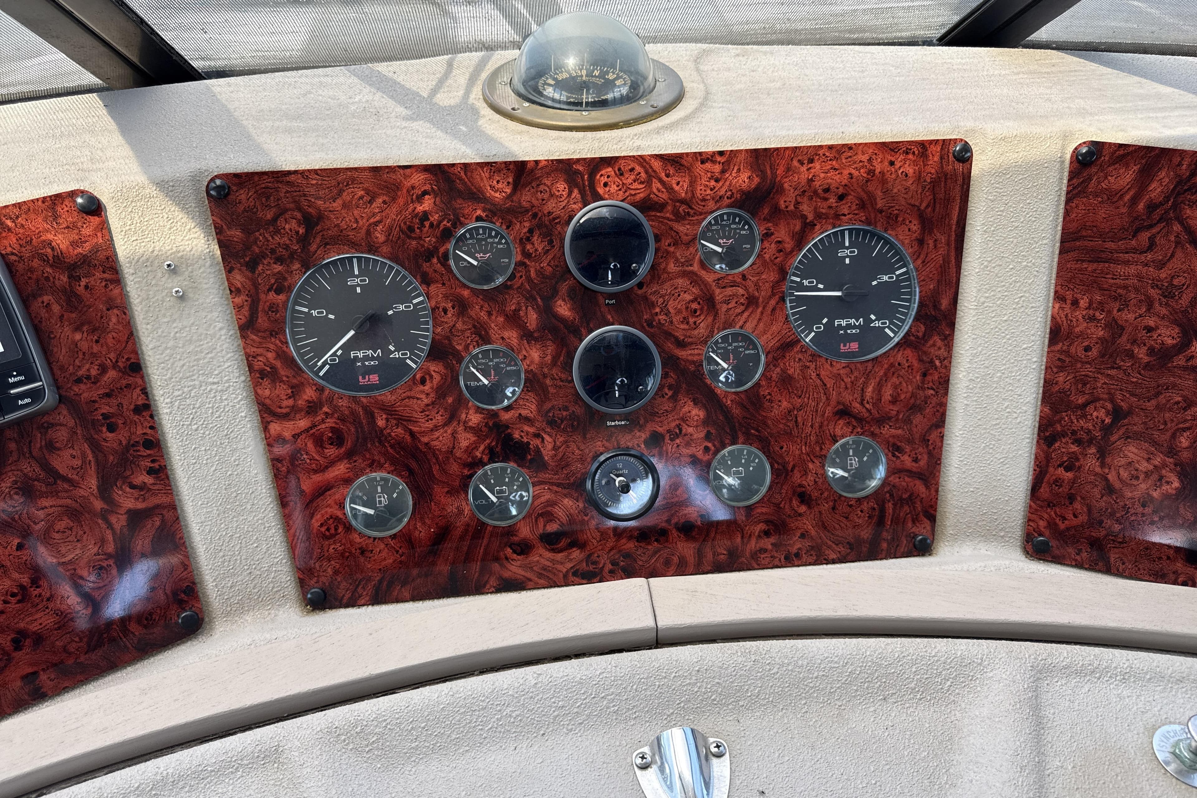 Dashboard of a 1997 Bayliner 4788 Pilot House Motoryacht with wood paneling and gauges.