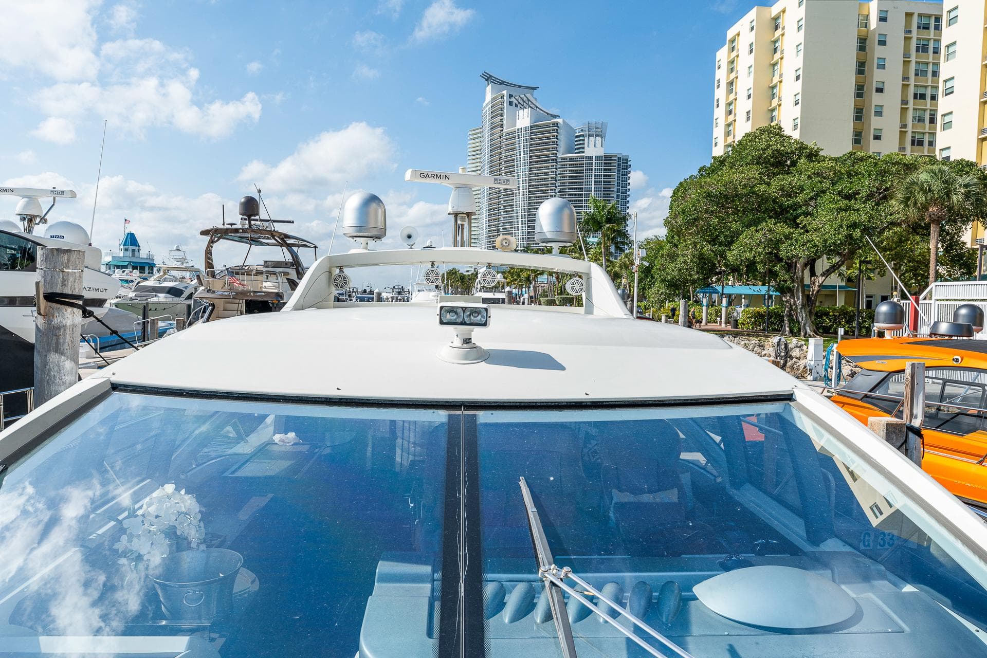 2007 Azimut 62S yacht docked in a marina with cityscape background.