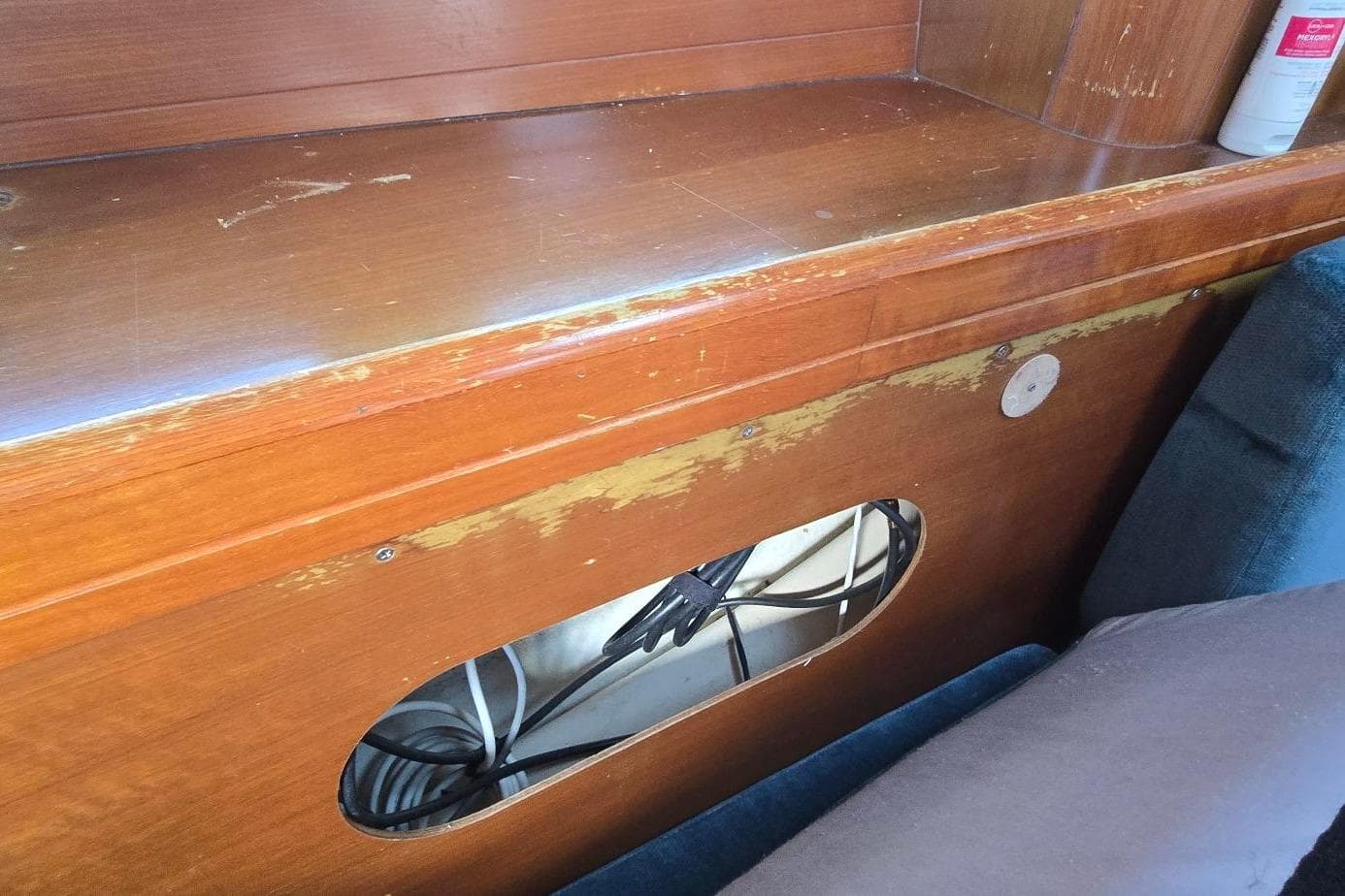 Worn wooden interior of a 1998 Beneteau Oceanis 411 sailboat, showing exposed wiring.
