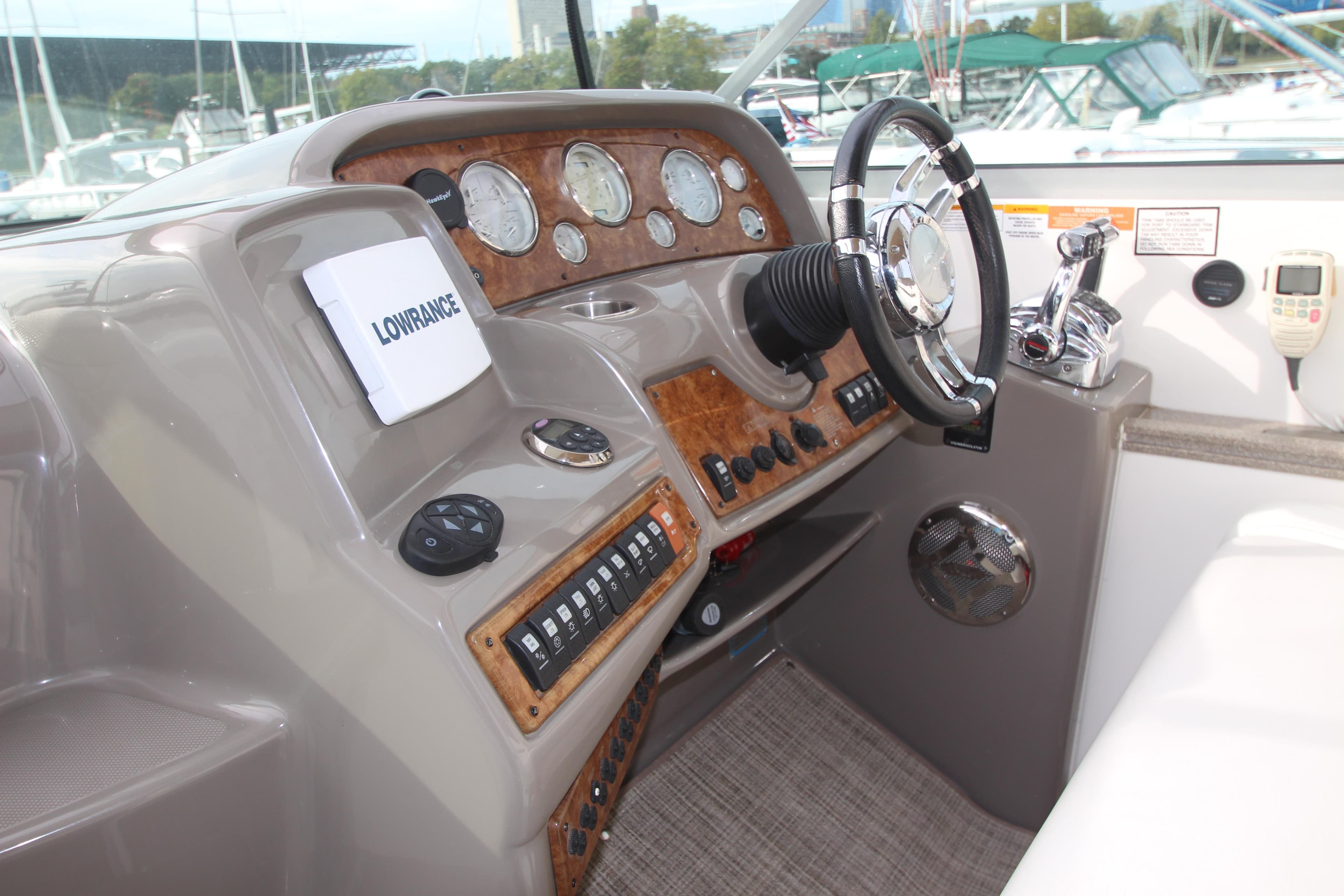 2008 Rinker 330 Express Cruiser helm with steering wheel and control panel.