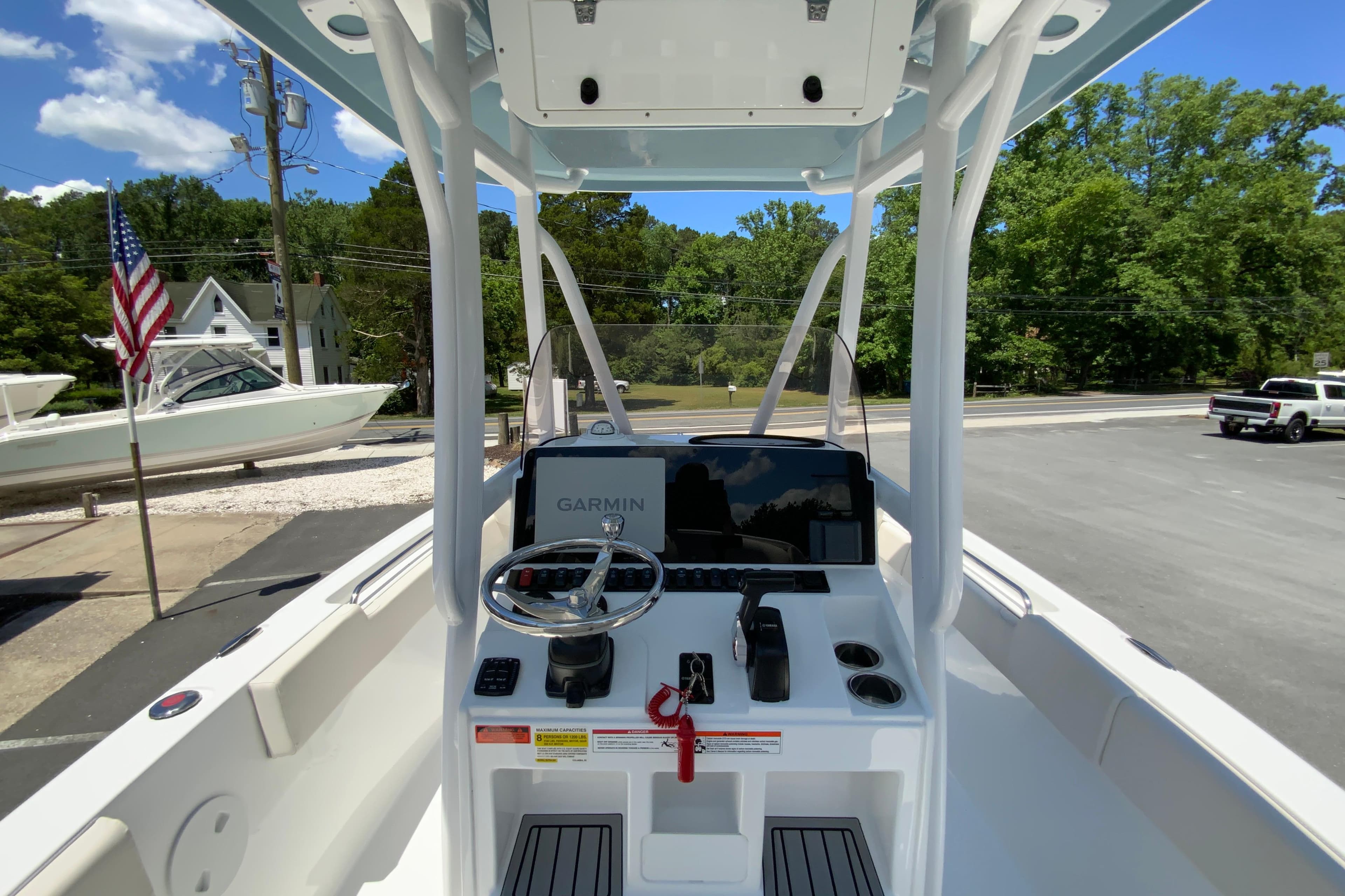 2024 Sea Hunt Ultra 234 boat console with Garmin navigation, parked outdoors.