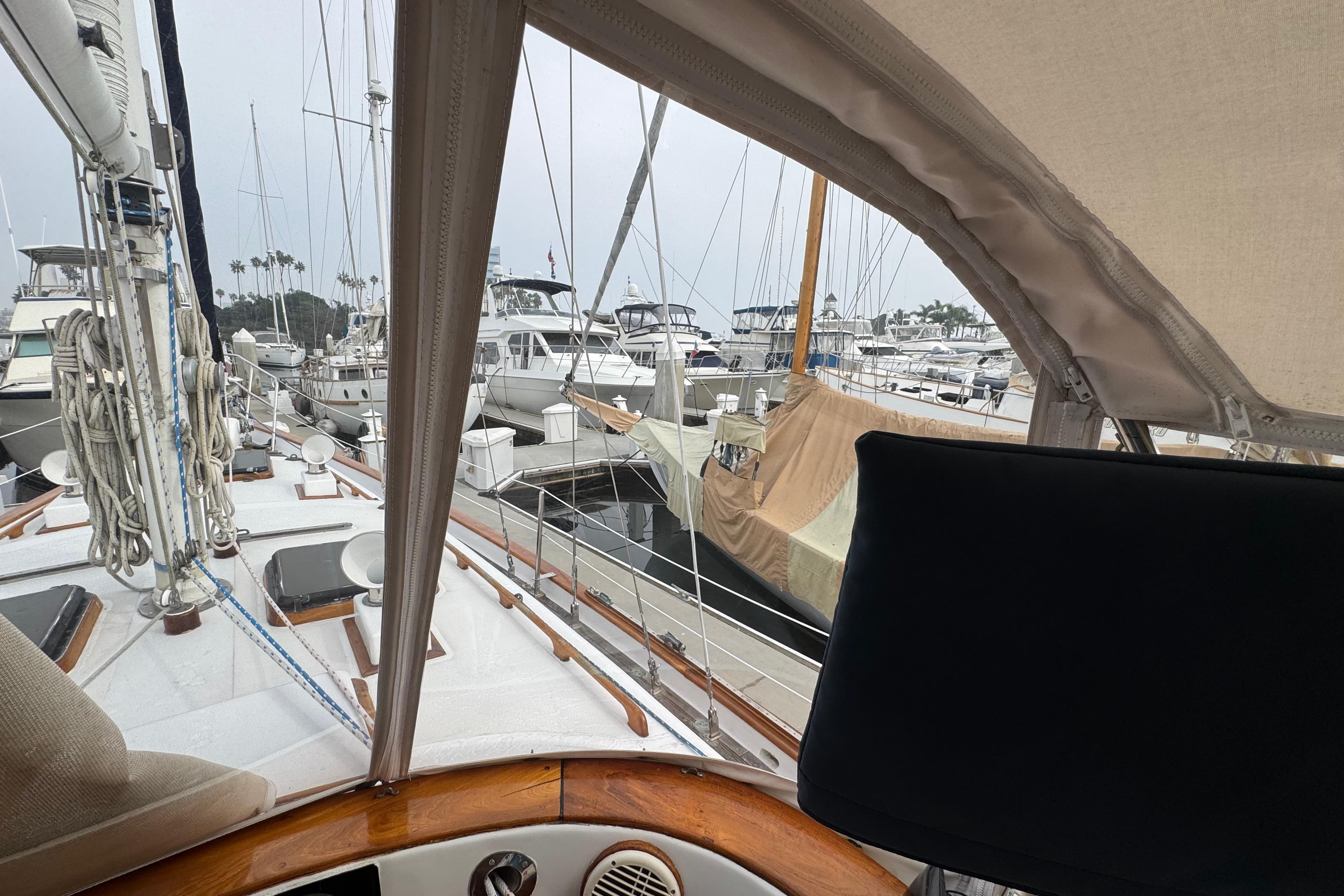 View from a 1978 Robert Perry 47 sailboat docked in a marina with other boats.