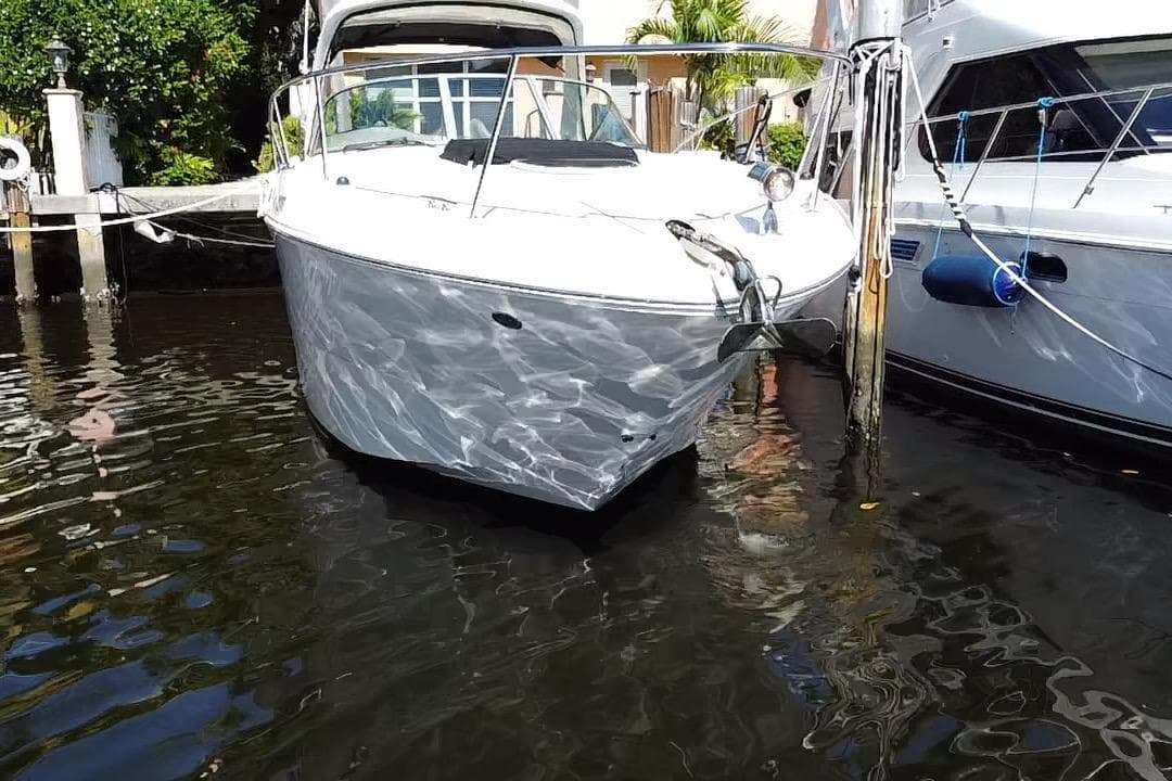 2012 Sea Ray 330 Sundancer yacht docked in sunny marina.