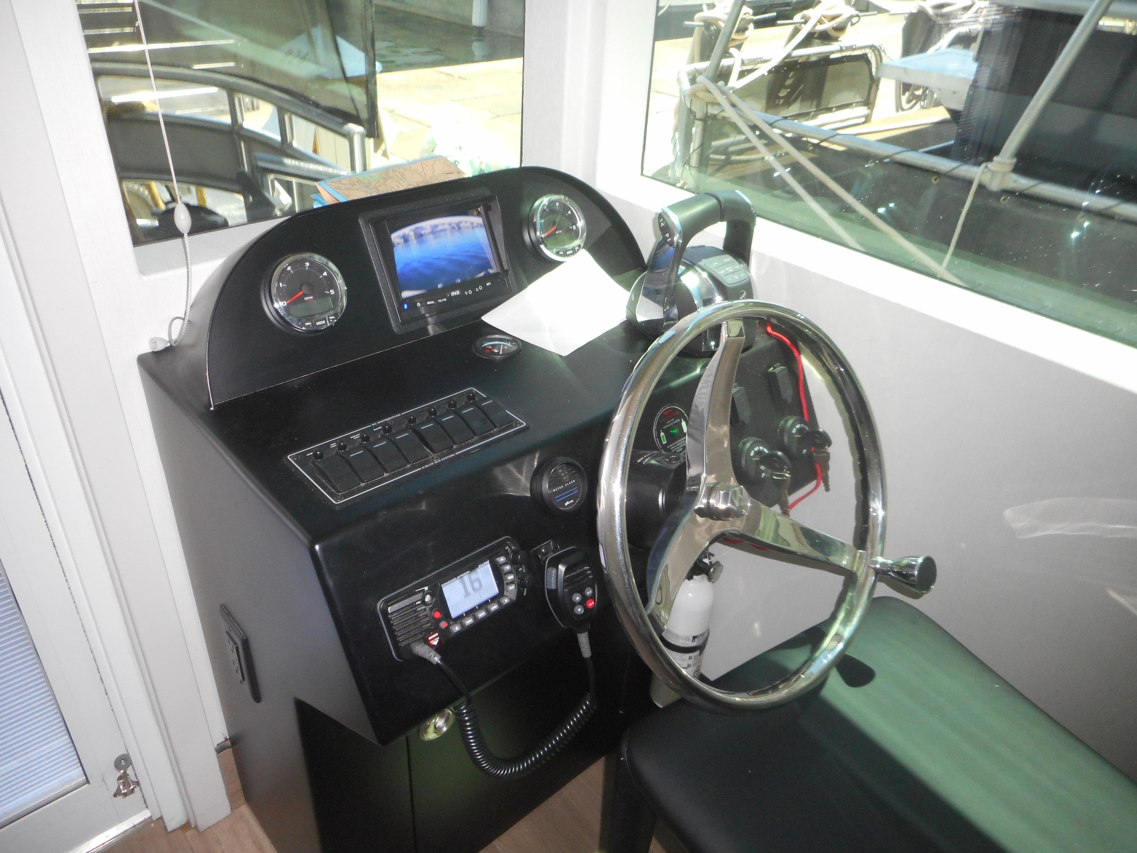 Control panel of Adonia Obsession Trip #12, 2021 model, featuring steering wheel and gauges.