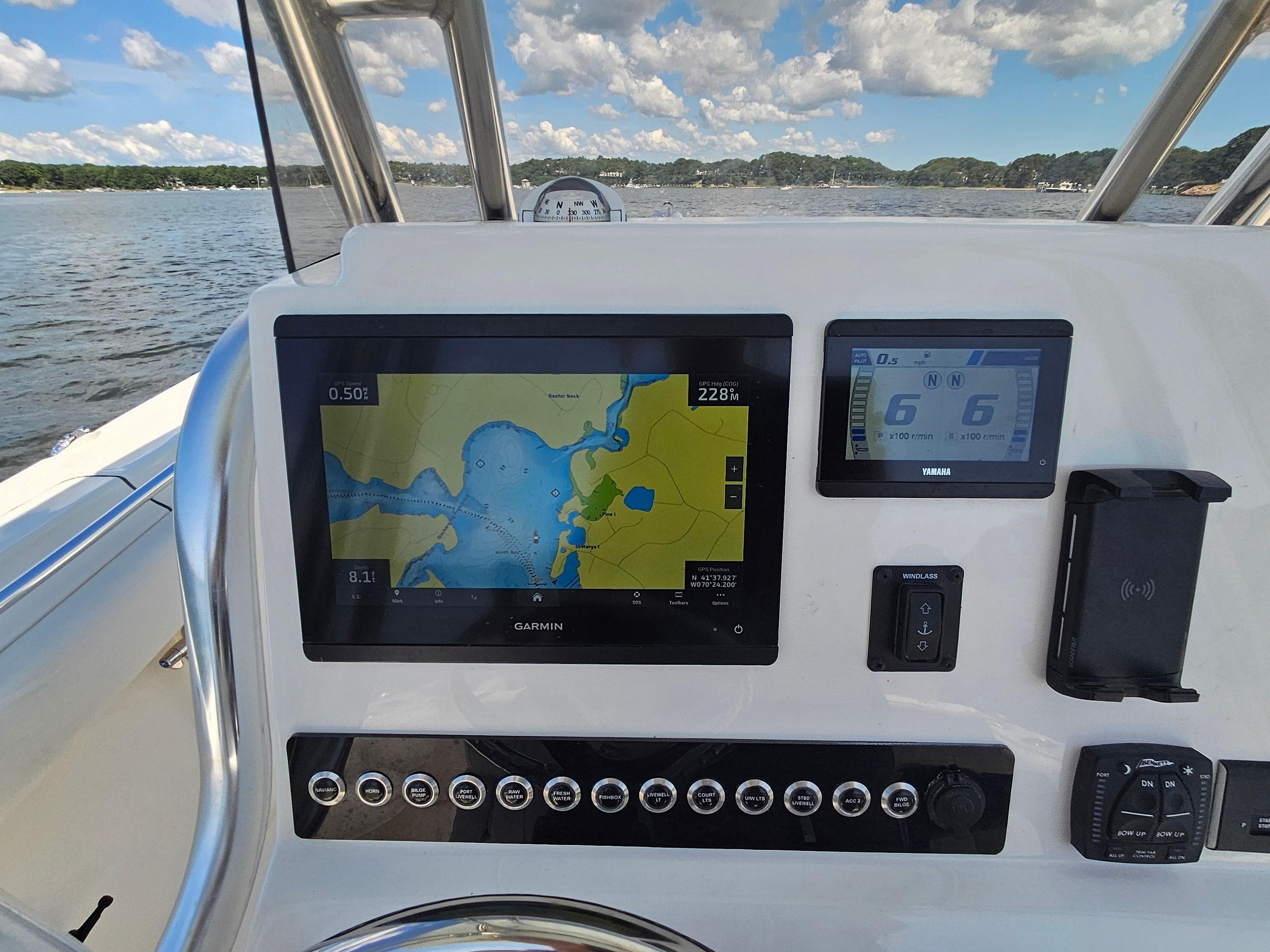2024 Key West 244 Center Console boat dashboard with Garmin navigation system on open water.