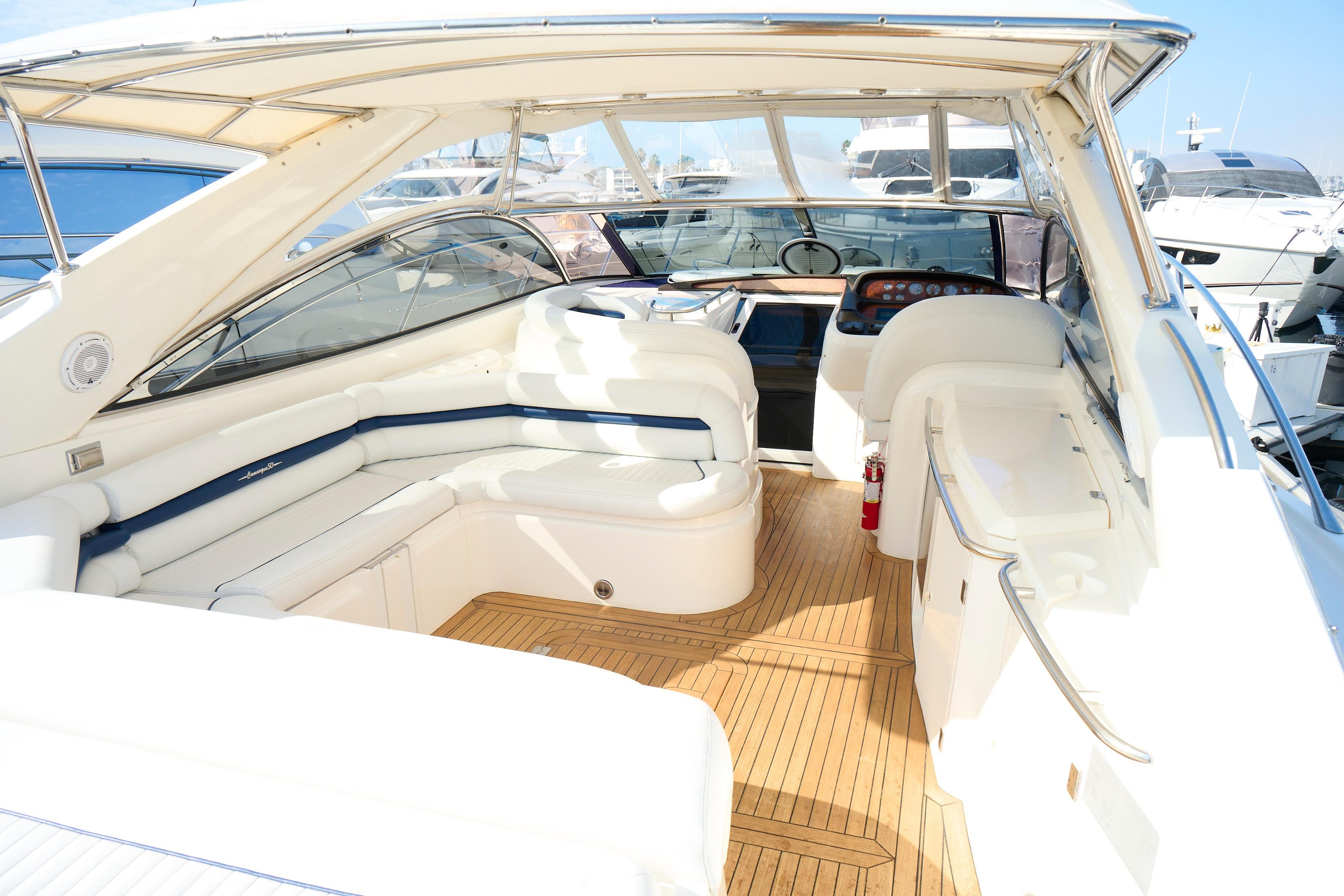 Luxurious Sunseeker Camargue 50 yacht interior, 2000 model, featuring elegant seating and wooden flooring.