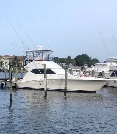 2005 Rampage 45 Convertible yacht docked at harbor.