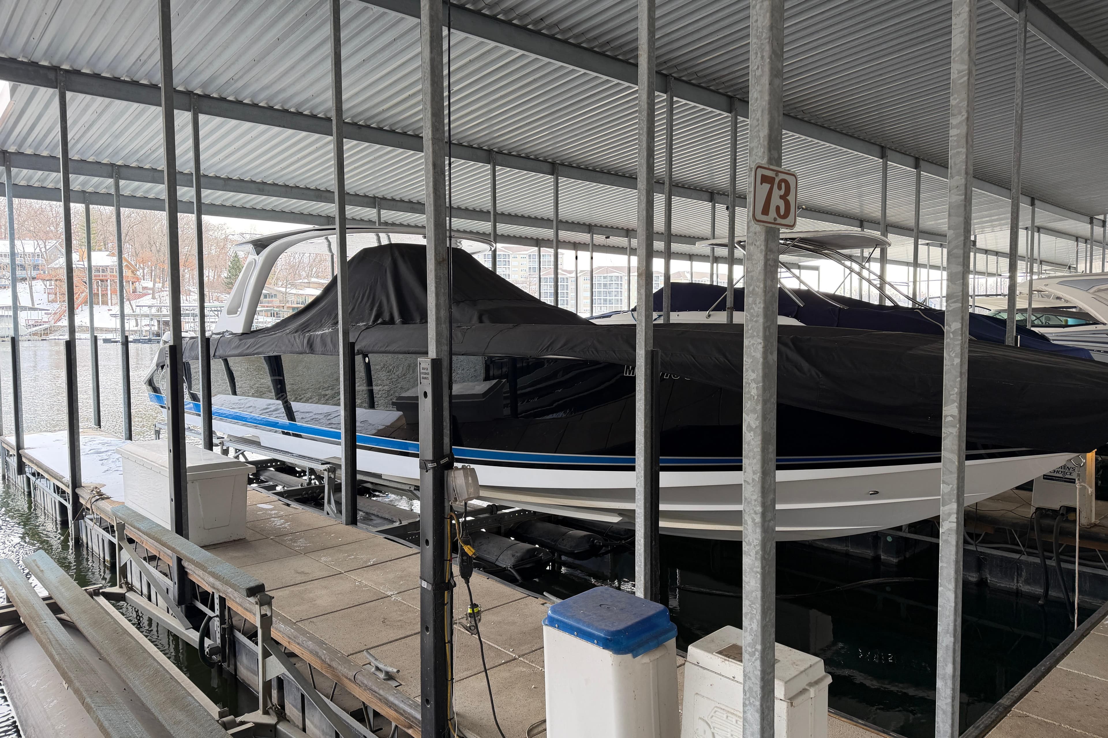 2017 Cigarette 41' GTR boat docked under a covered marina slip.