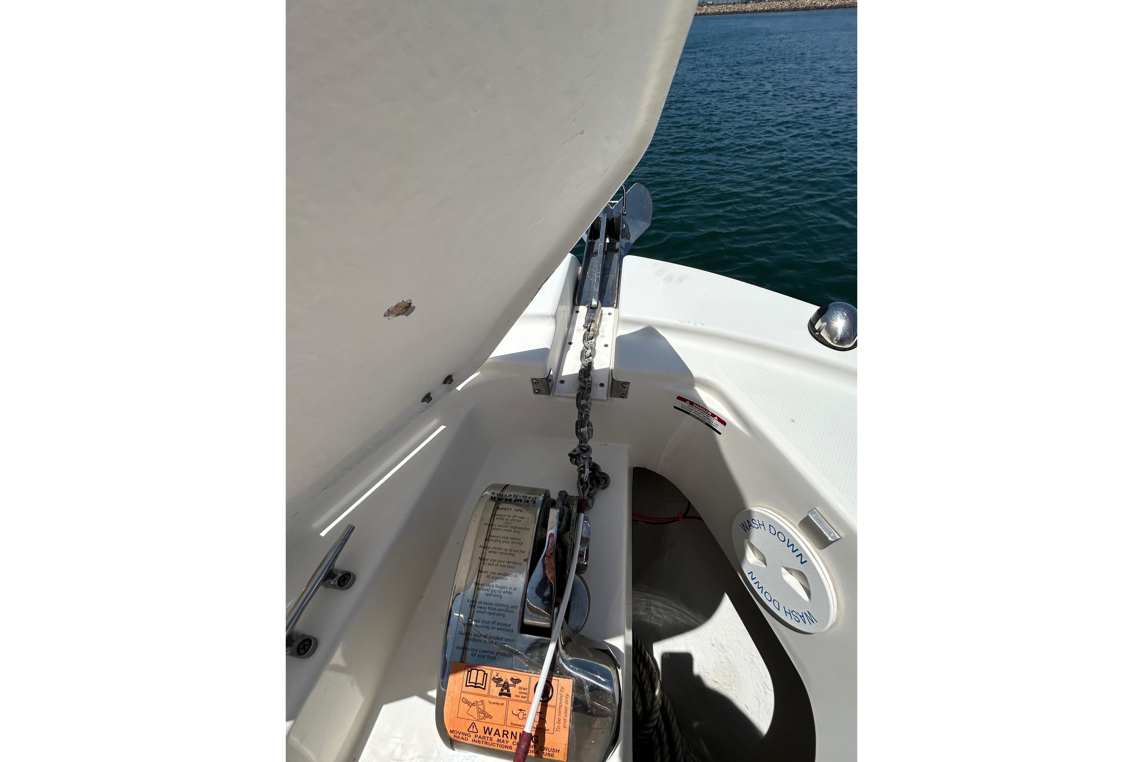 2007 Robalo R305 Walkaround anchor compartment with chain and washdown area.