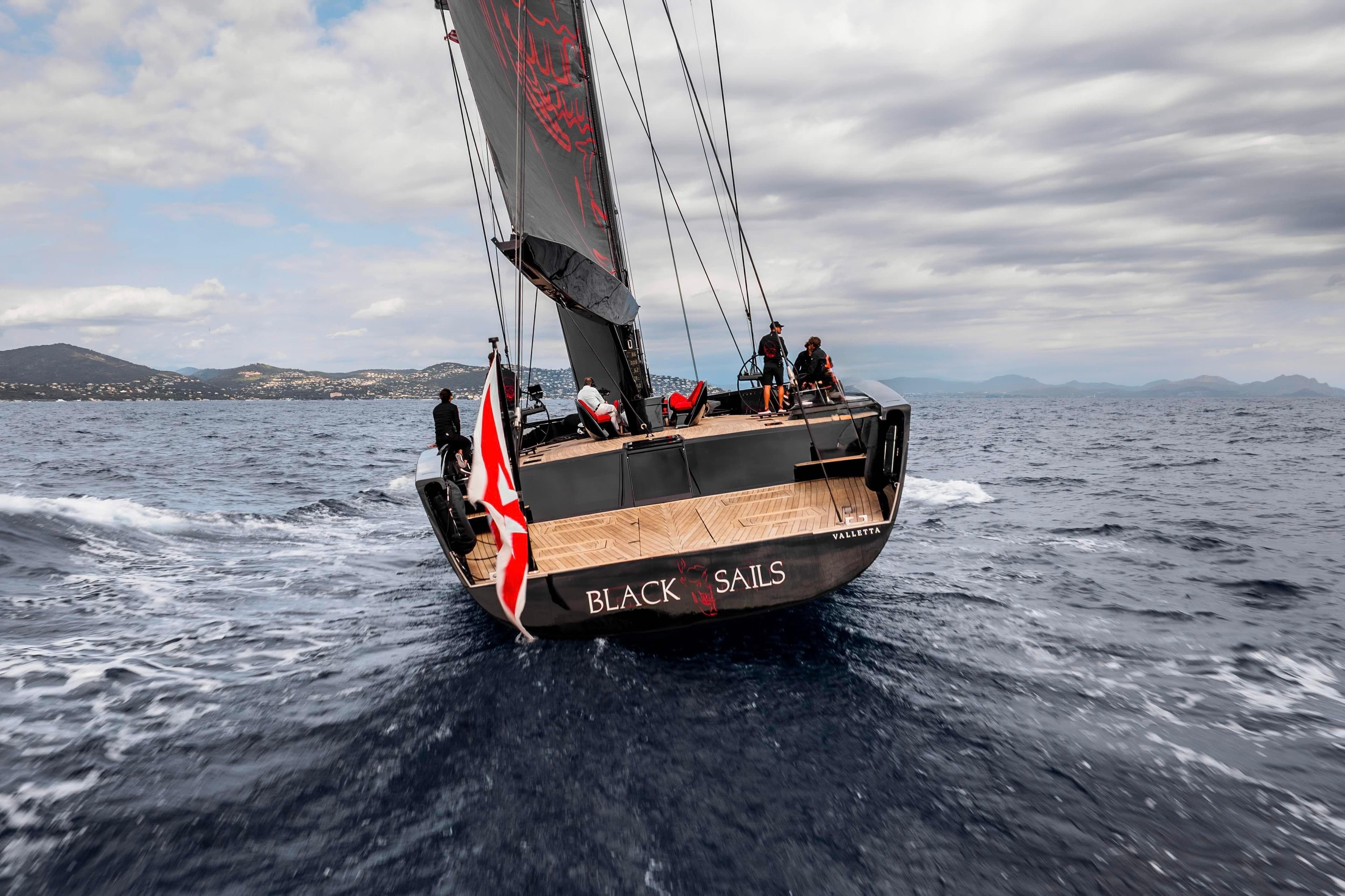 Sailing yacht Wally 130, 2009 model, navigating open sea under cloudy skies.