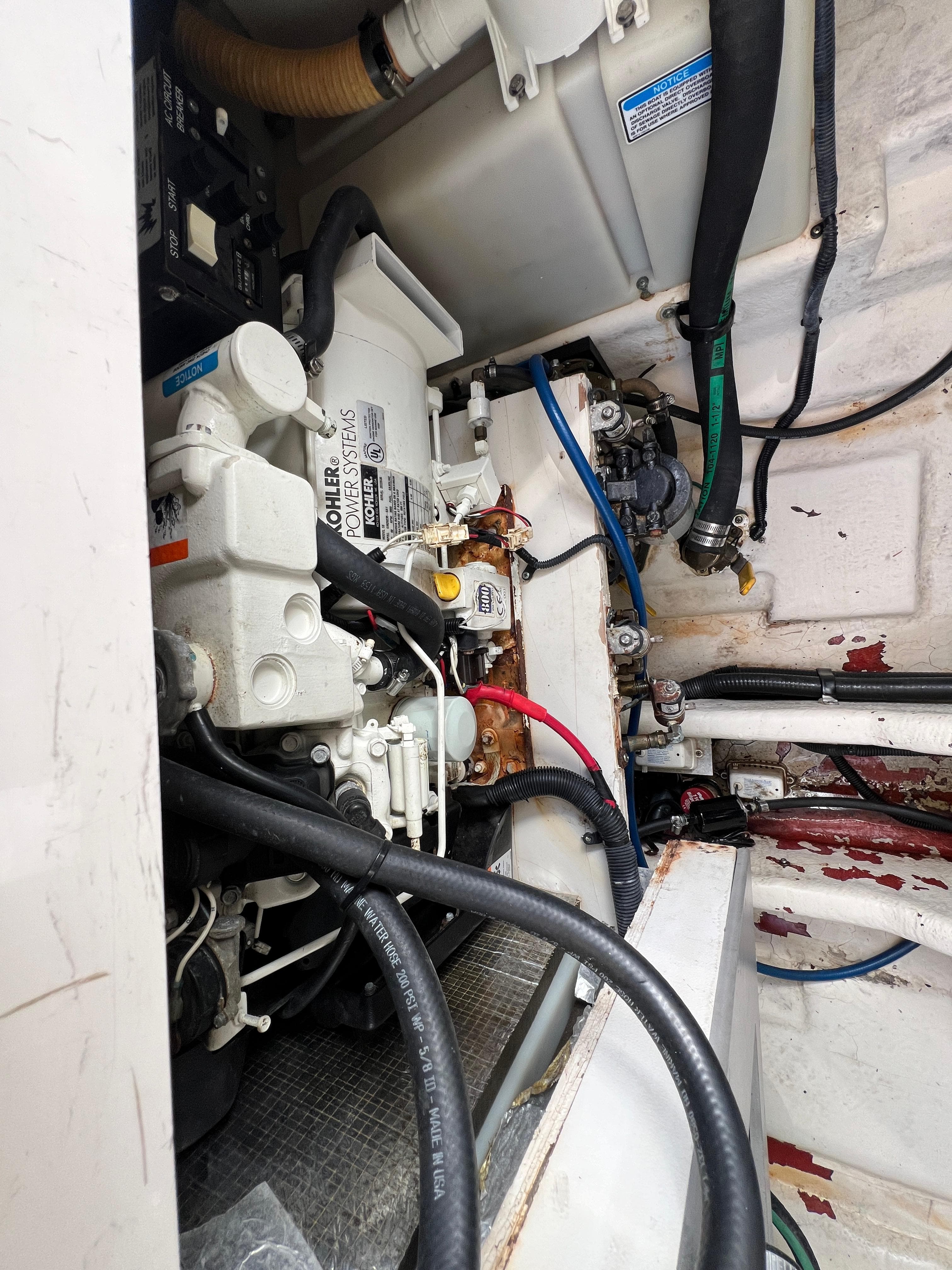 Engine compartment of a 2005 Sea Ray 280 Sundancer boat, showing mechanical components and wiring.
