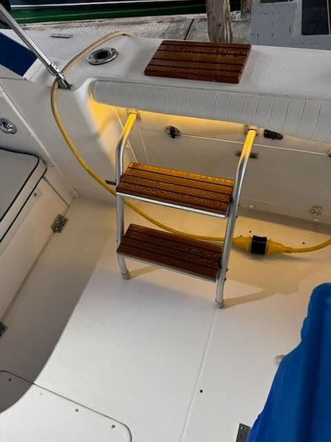 Interior of a 1984 Bertram 30 yacht with illuminated steps.