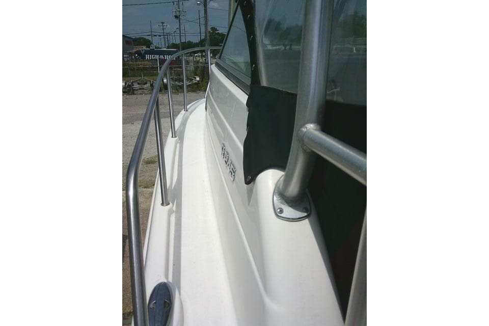 2008 Robalo R245 Walkaround boat, side view with railing and window details.