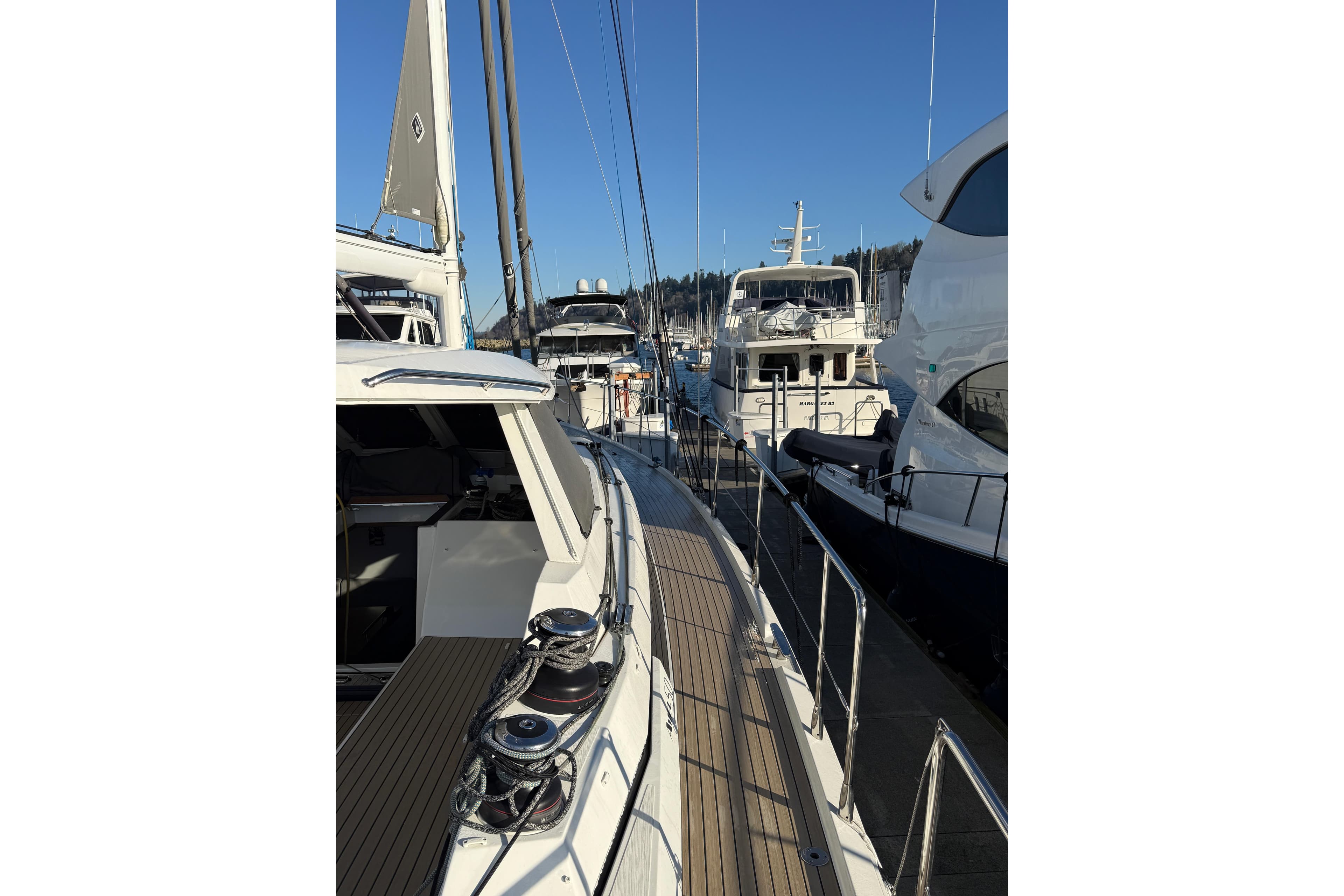 2020 Amel 50 yacht docked among other boats in a marina.