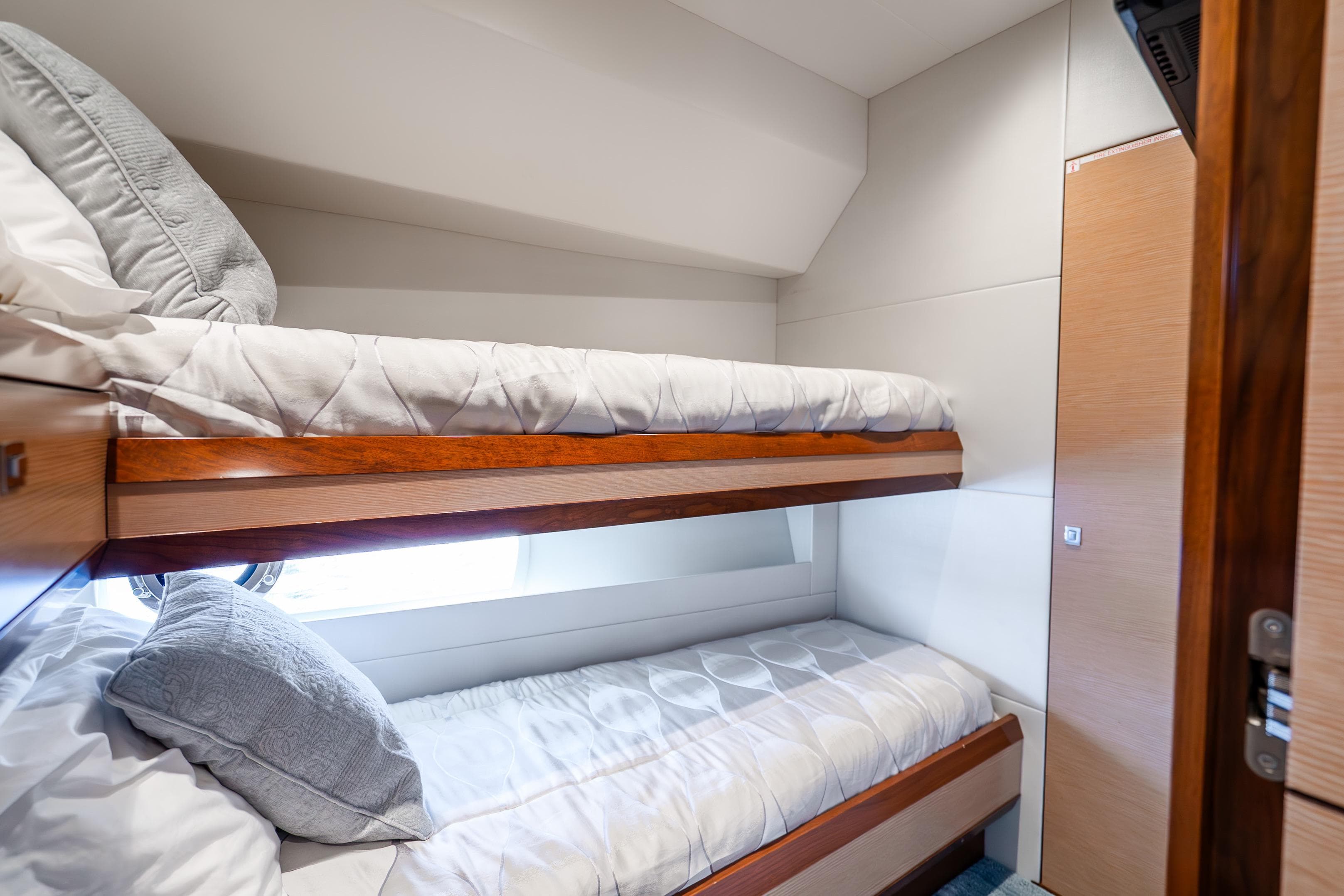 2021 Ocean Alexander 70E Motoryacht cabin with cozy bunk beds and modern design.