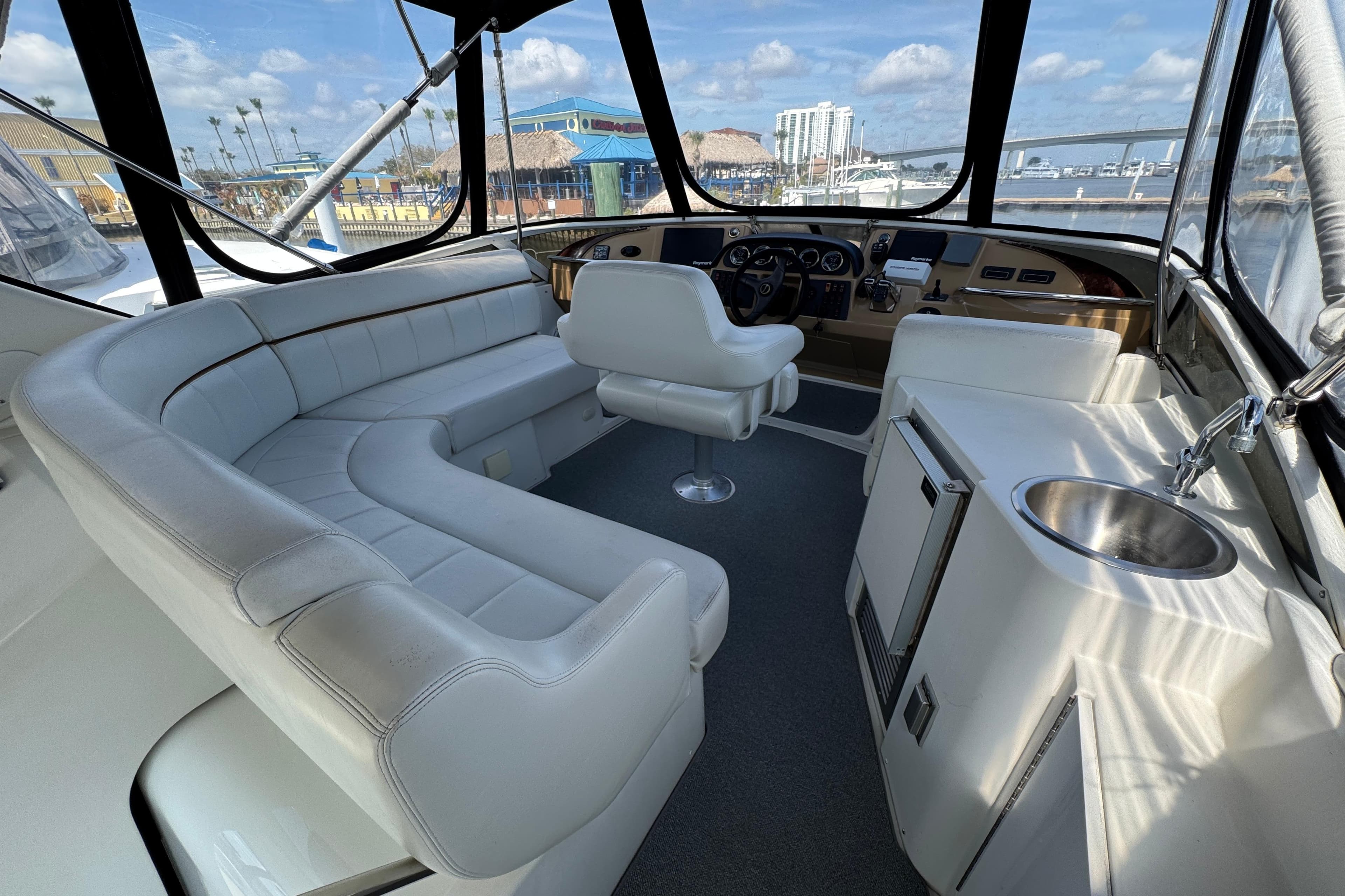 2004 Carver 444 Cockpit Motor Yacht interior with white seating and helm.