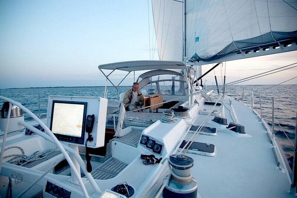 Sailing on a 1983 VATON 78 Sloop yacht with modern navigation equipment.