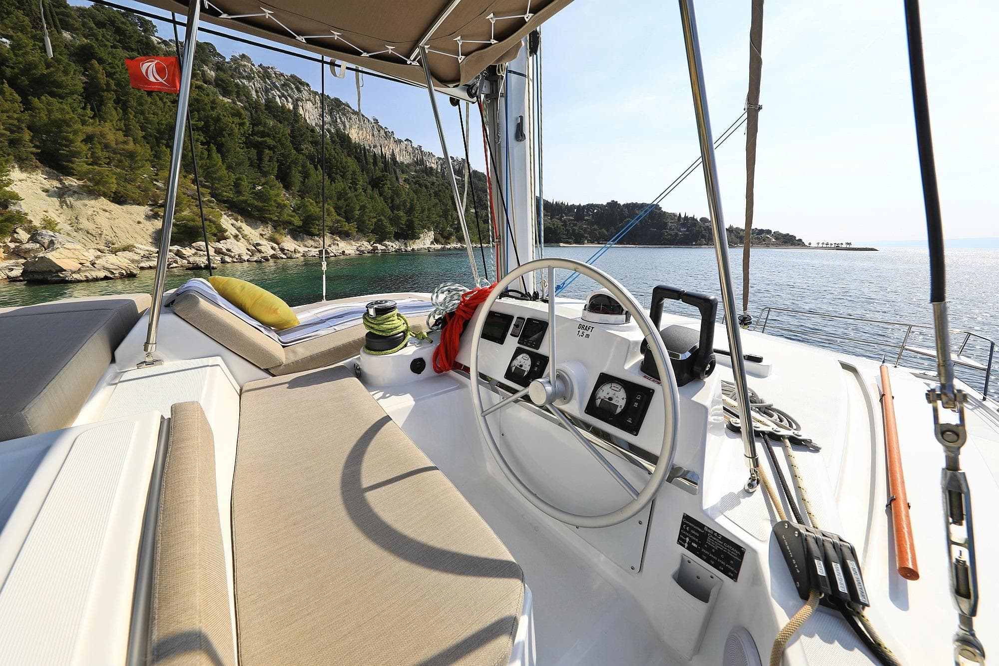 Helm of 2021 Bali 4.2 catamaran with scenic coastal view.