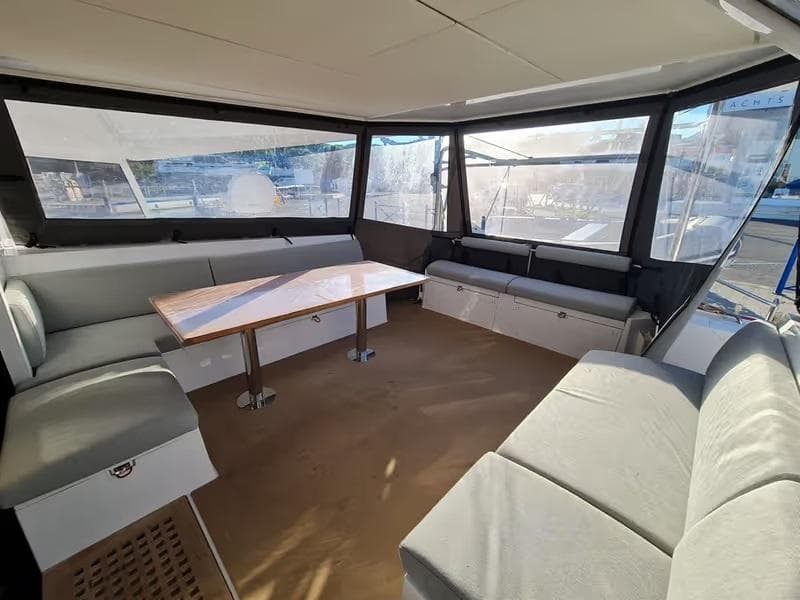 Spacious interior of 2019 Nautitech 46 Fly catamaran with comfortable seating and large windows.