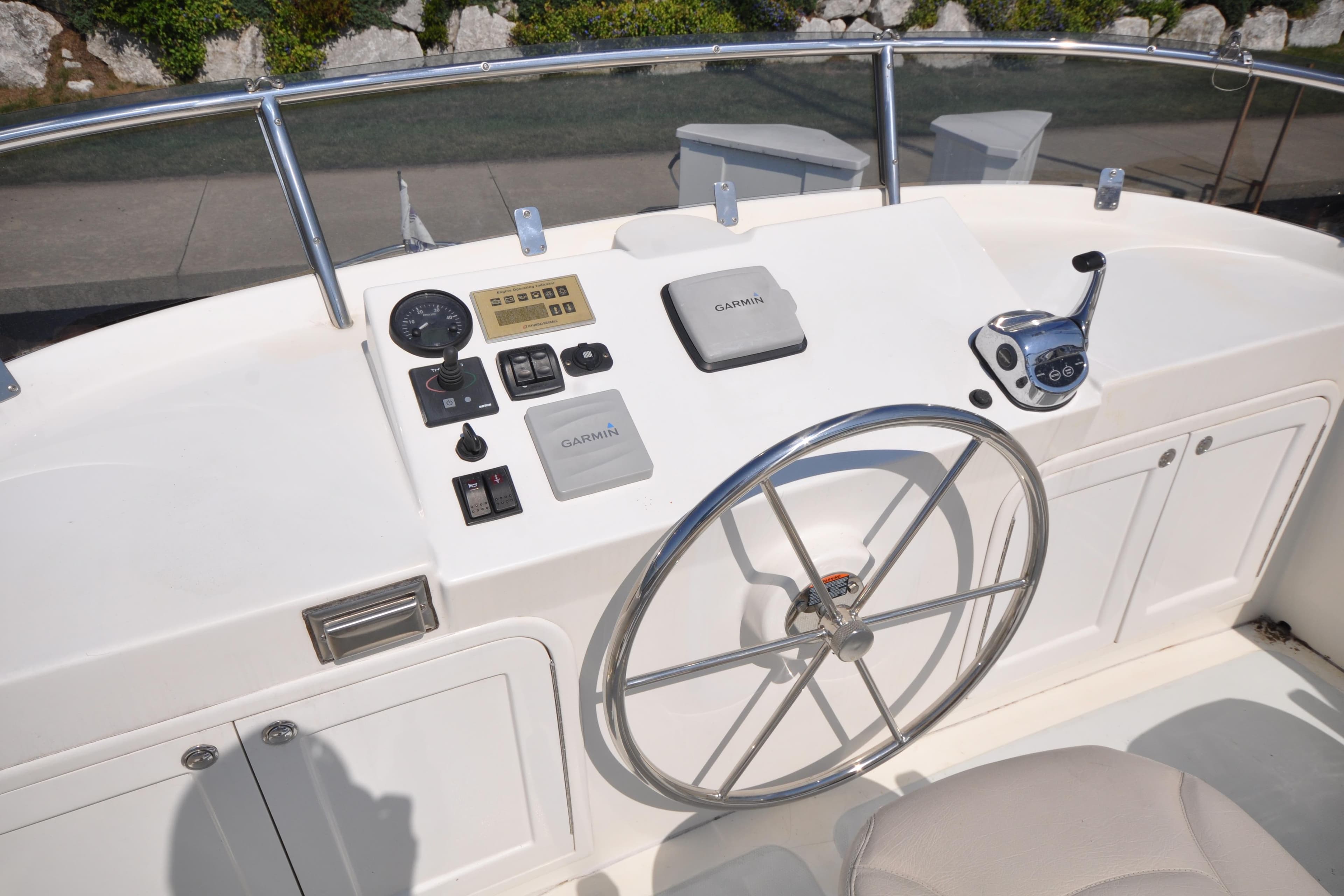Helmsman Trawlers 31 Sedan 2015 helm with Garmin navigation and control panel.
