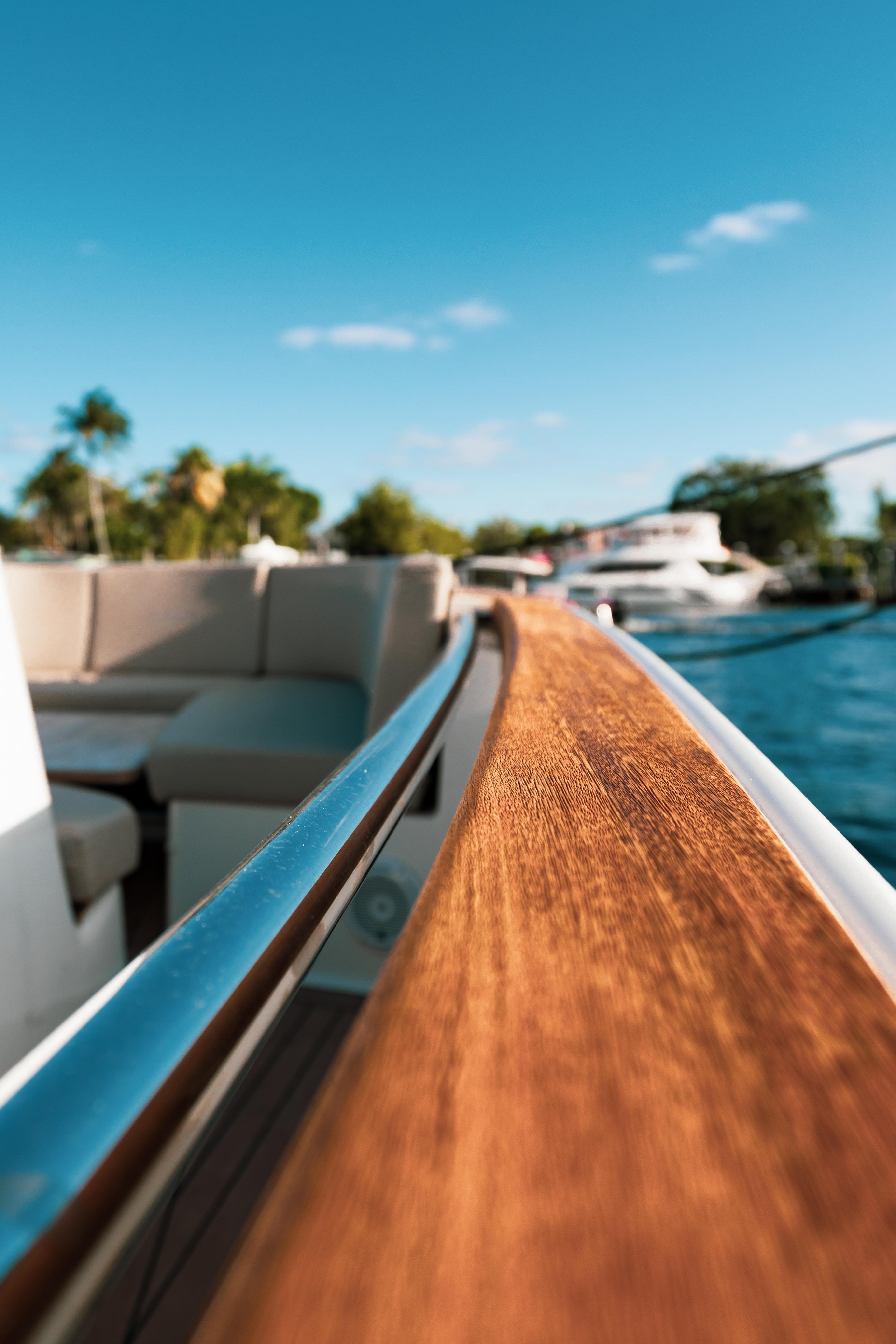 2022 Fjord 38 Open yacht with sleek wooden railing and scenic water view.