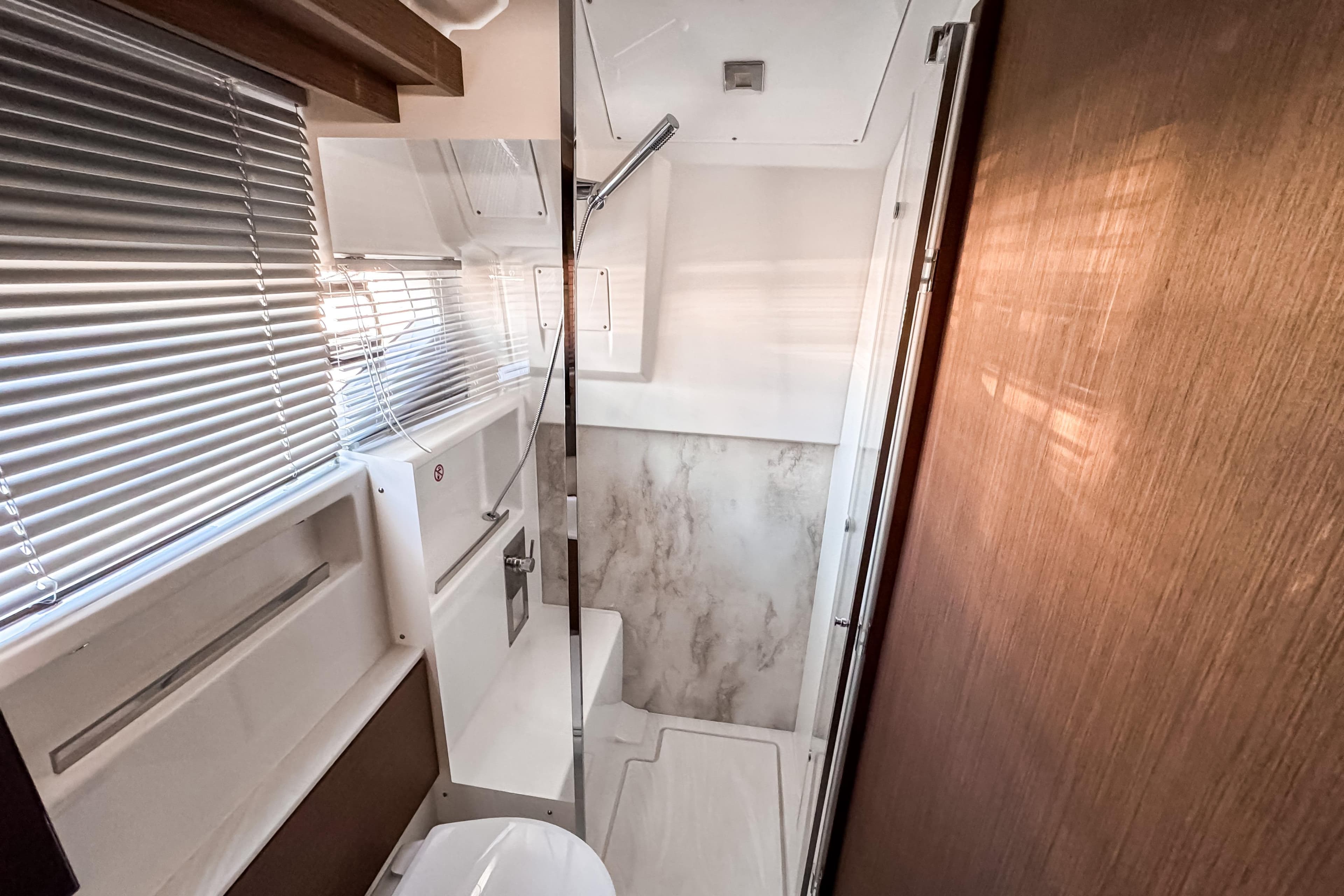 Modern bathroom interior of 2026 Wellcraft 44 Explorer yacht with sleek design and natural lighting.