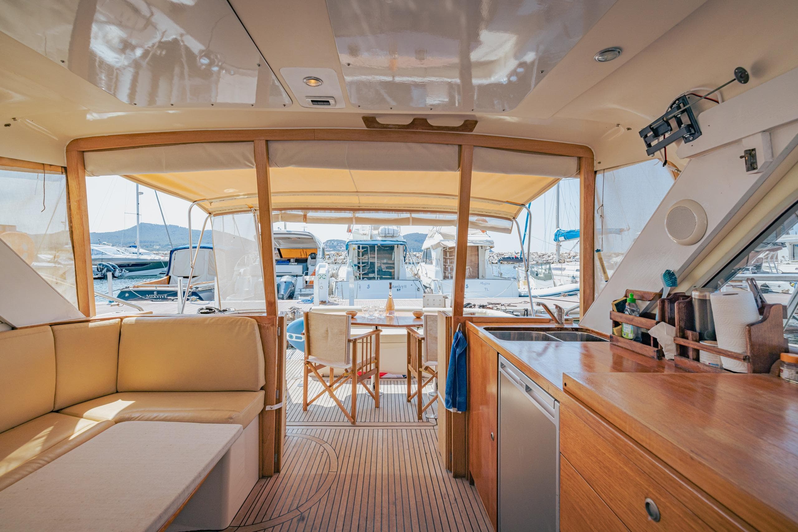 Interior view of 2006 Arcoa Mystic 39 yacht with seating and kitchenette.