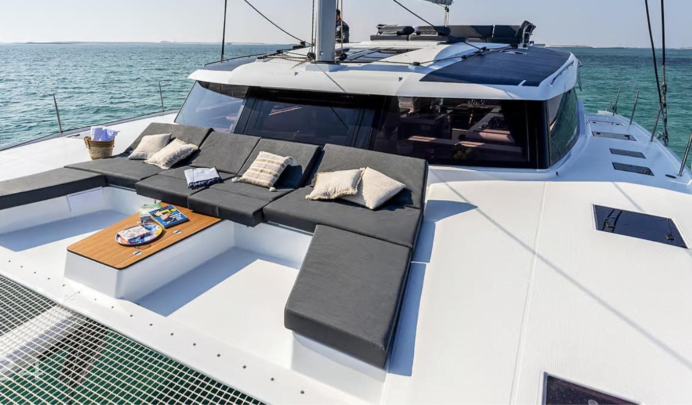 2025 Fountaine Pajot Catamaran Aura 51 with luxurious deck seating and ocean view.