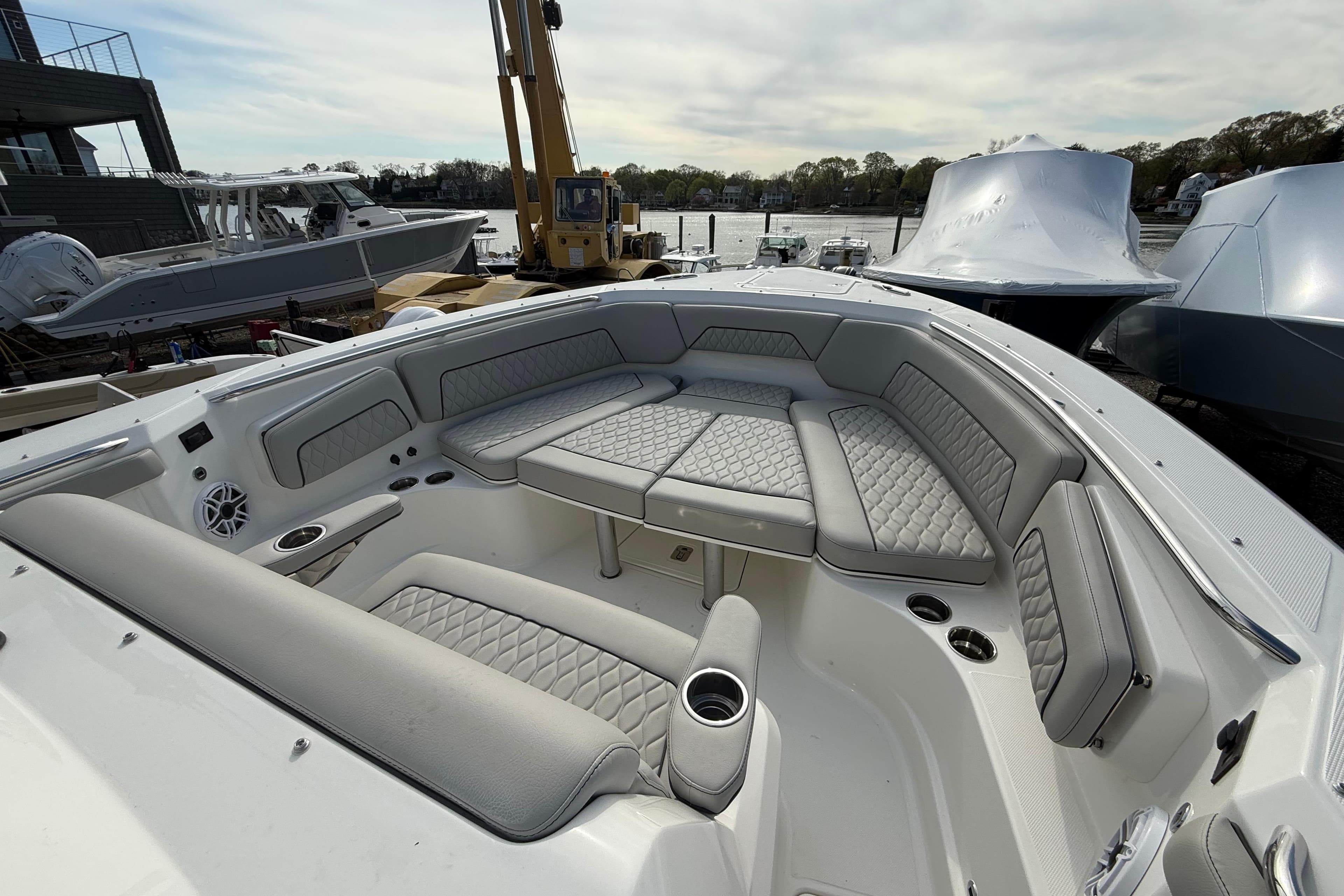 2026 Pursuit S 328 Sport boat with luxurious seating and modern design at a marina.