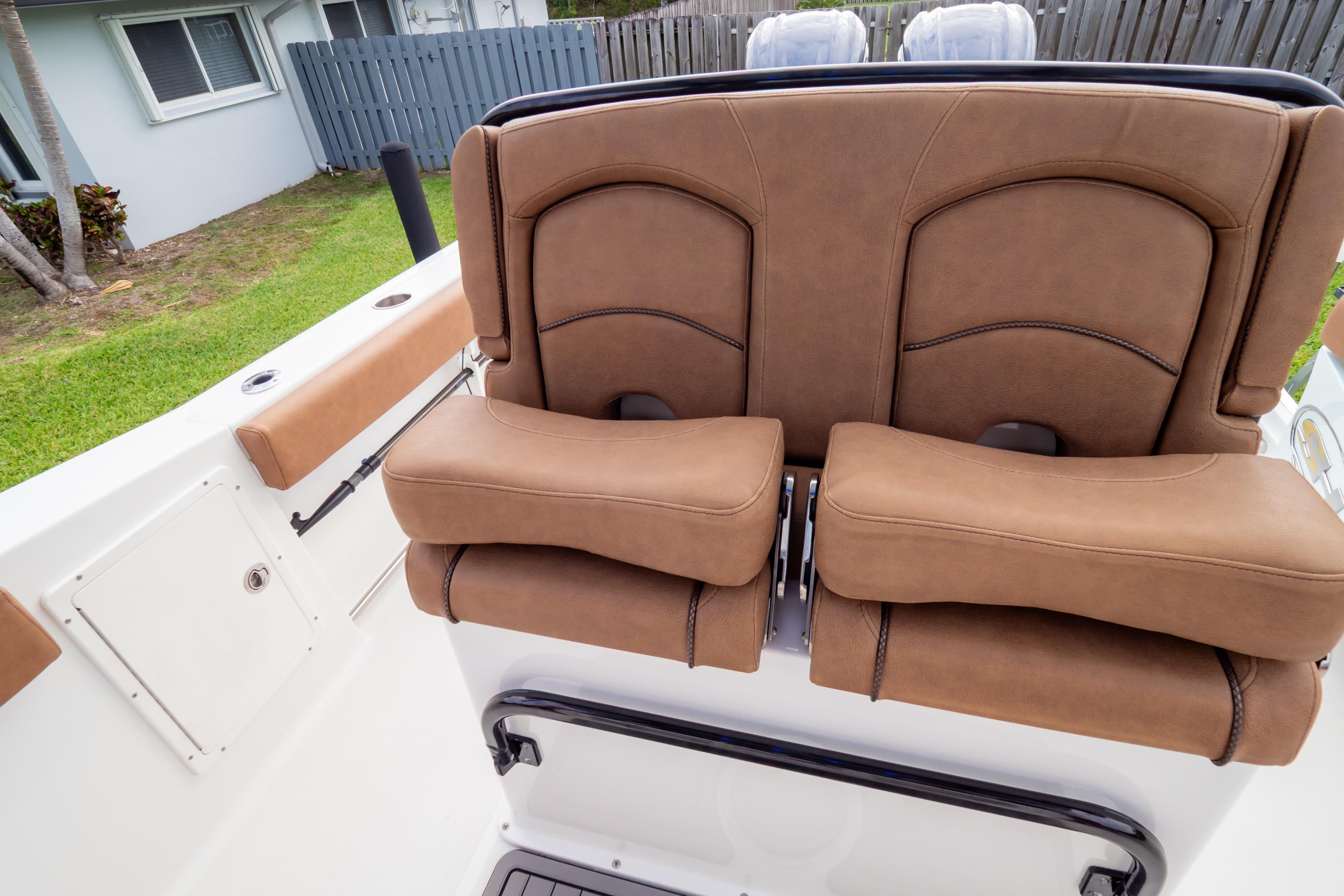 2021 Sea Hunt Gamefish 27 boat with brown leather seating and white deck.
